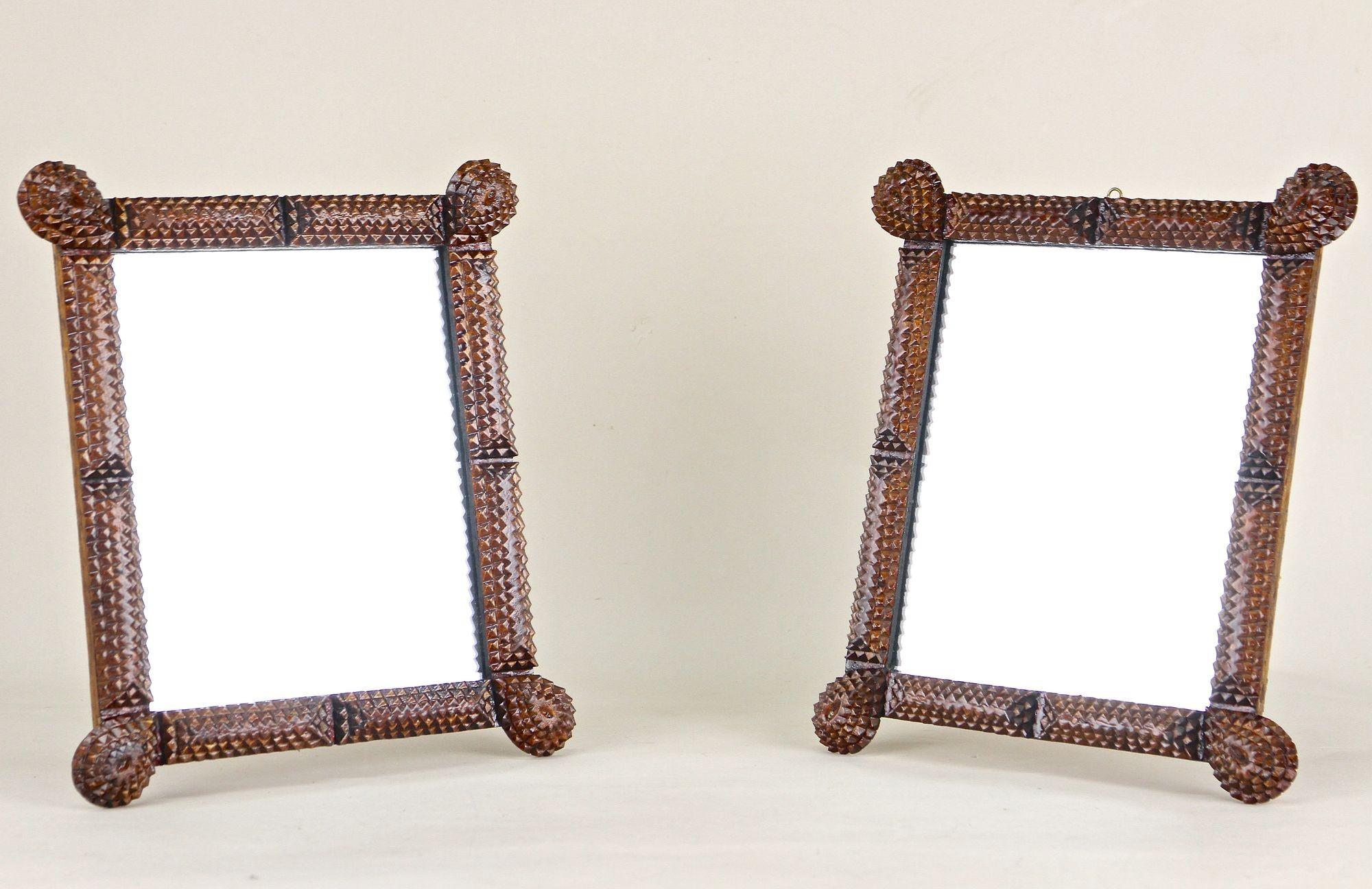 Exceptional set of two small Tramp Art wall mirrors from the period in Austria around 1870. Elaborately hand carved out of basswood, this beautiful antique rustic mirors were made in the so-called 