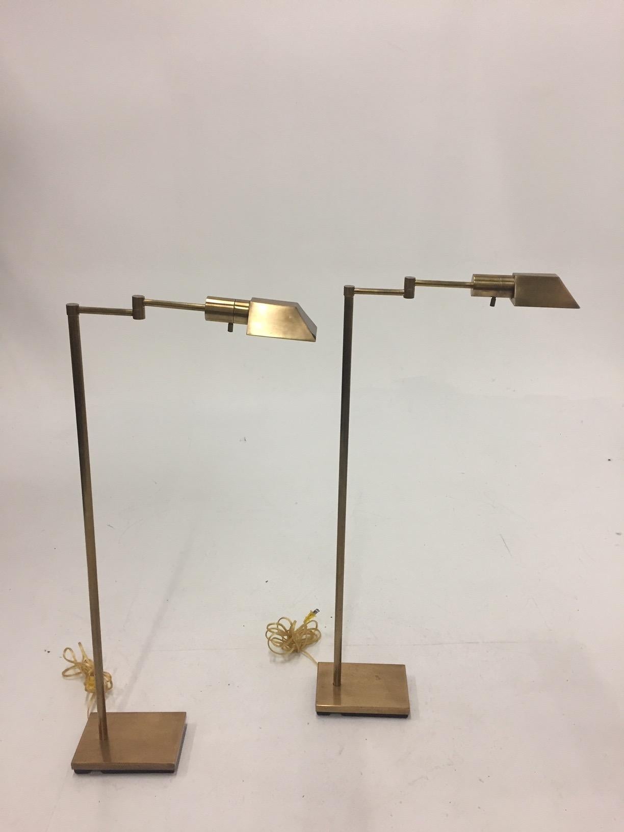 Functional and Mid-Century Modern cool pair of brass swing arm adjustable floor lamps. When fully opened 20