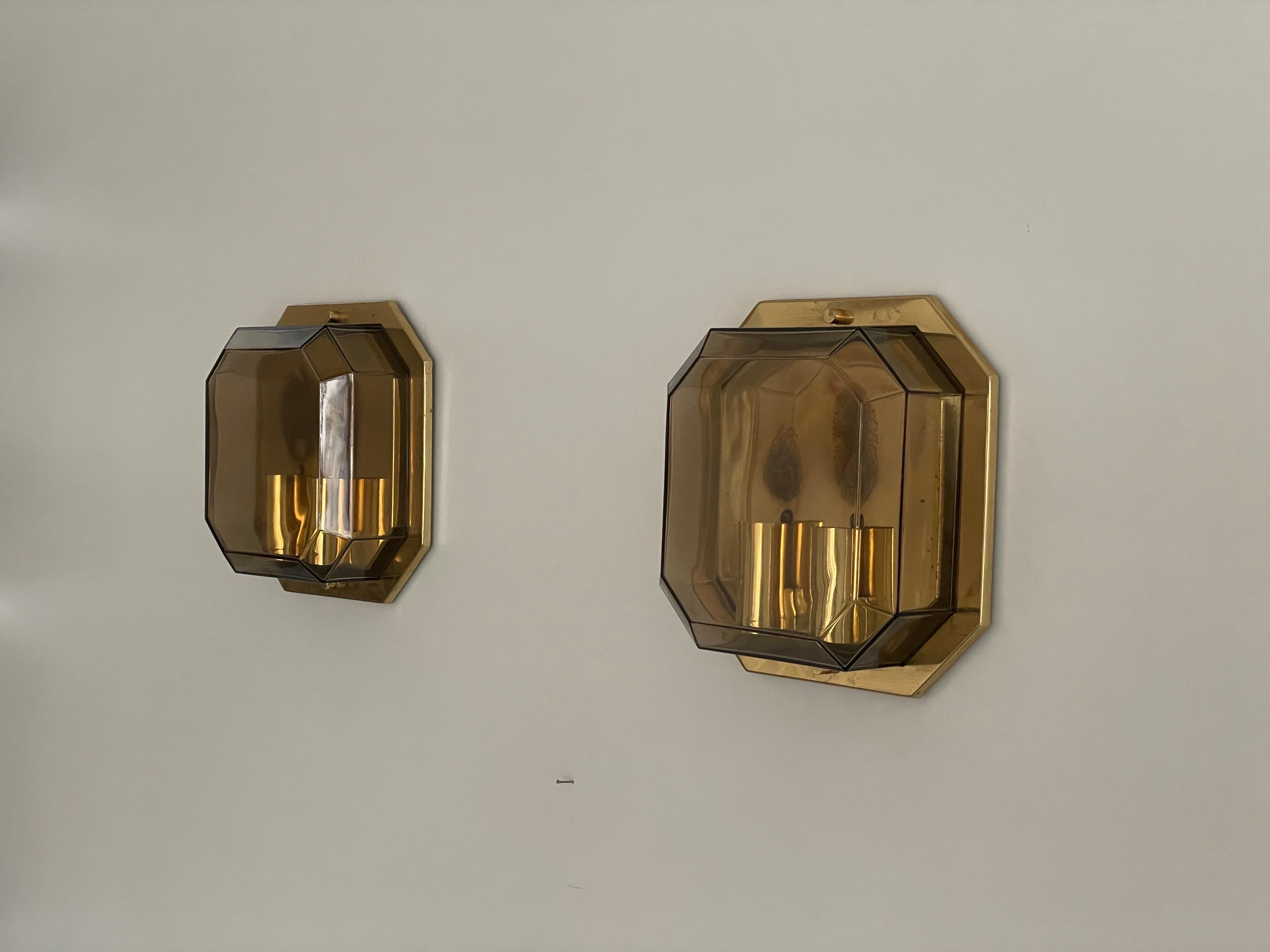 Pair of Smoke Glass & Brass Sconces by Limburg, 1970s, Germany

Very nice high quality wall lamps.

Lamps are in very good vintage condition.


These lamps works with 2x E14 standard light bulbs. 
Wired and suitable to use in all countries. (110-220
