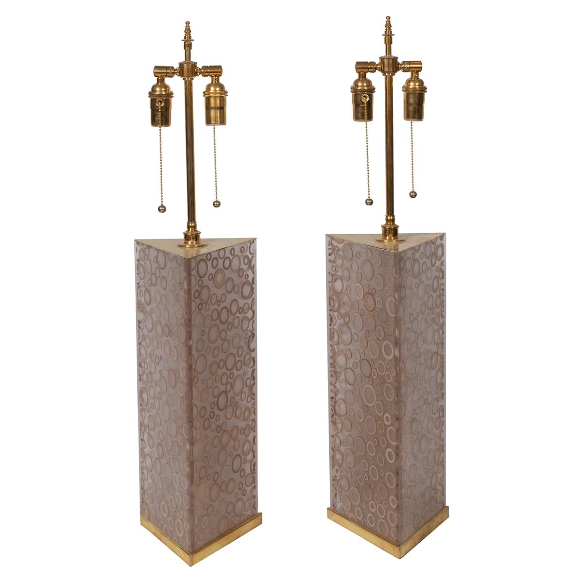 Pair of smoked acrylic lamps with ring motif and brass hardware.