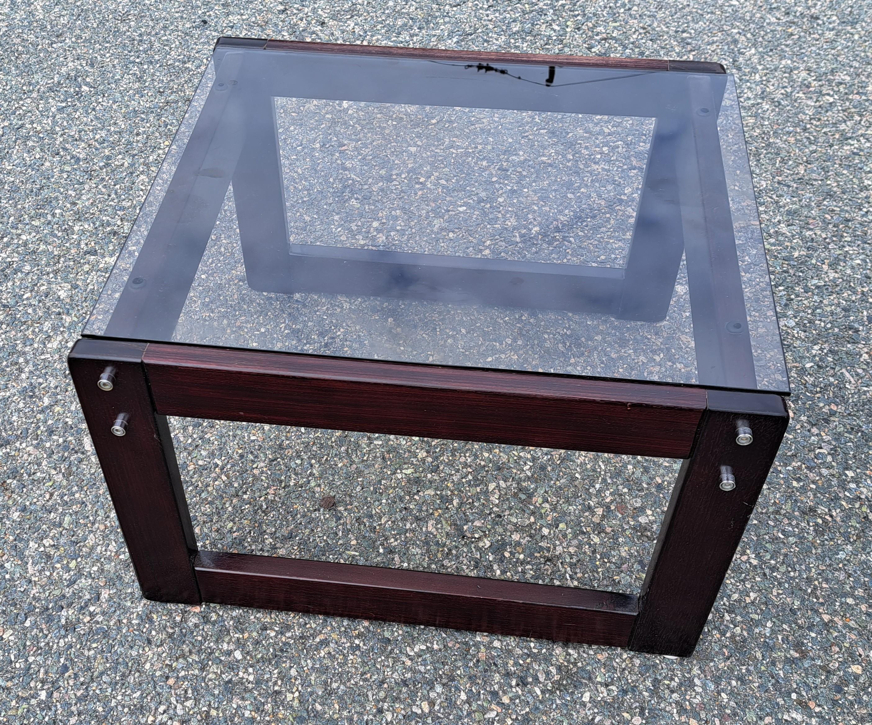 Pair of smoked glass top rosewood end tables. Tables are attributed to Percival Lafer. With protruding bolts against smooth red wood base. Convenient size and minimal design make these tables perfect for small or large spaces. 