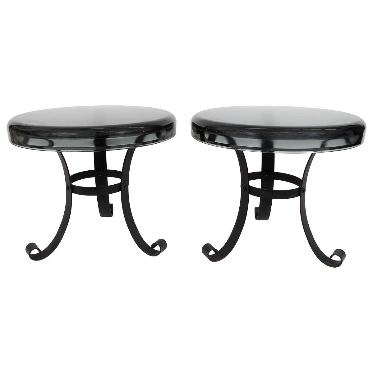 Pair of end tables from 1970s. The top is heavy, made of thick smoked glass.
Black metal bases.