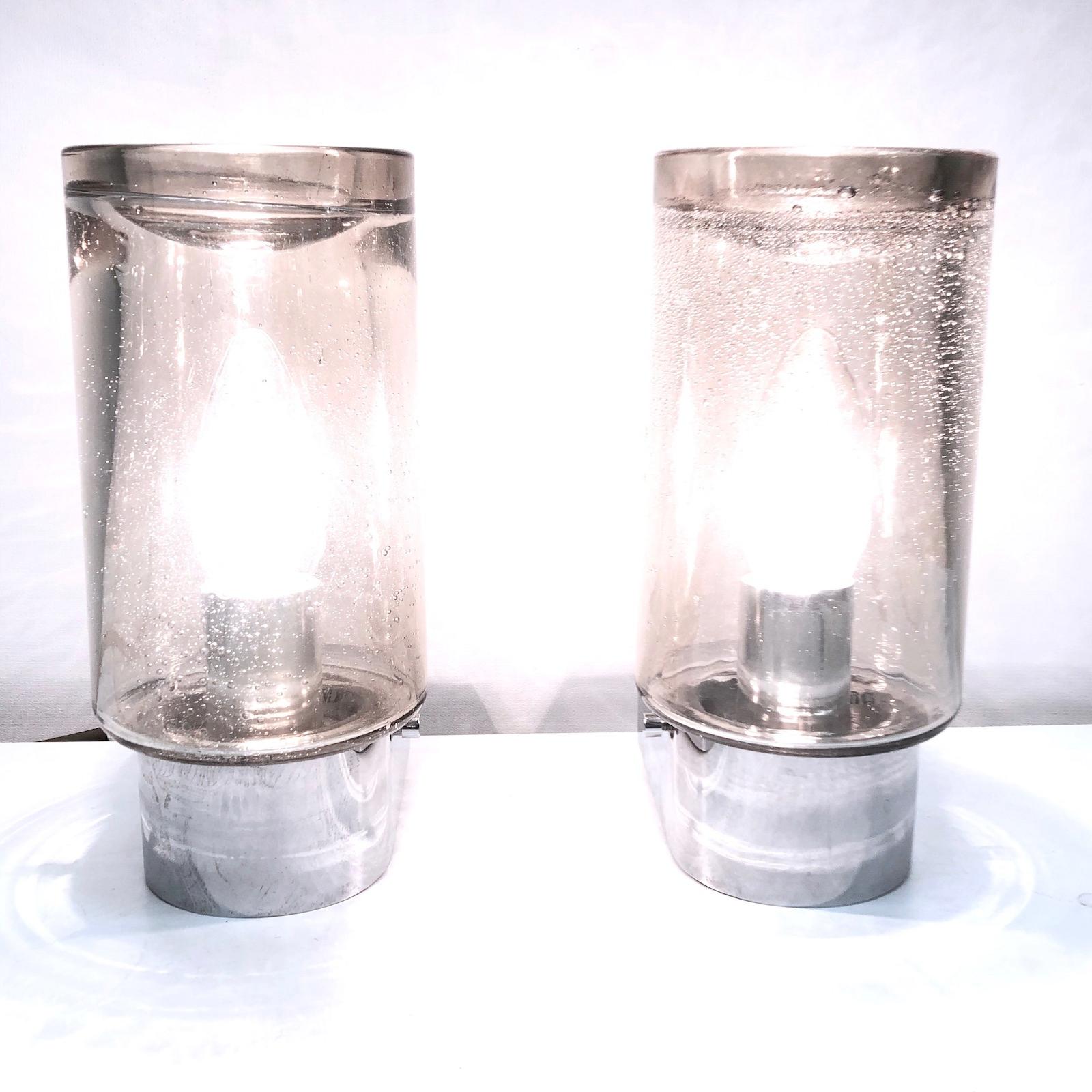 Petite sconces manufactured by Glashütte Limburg. It is a smoked tone glass on a chromed metal frame. Each fixture requires one European E14 / 110 Volt candelabra bulb, each bulb up to 40 watts.