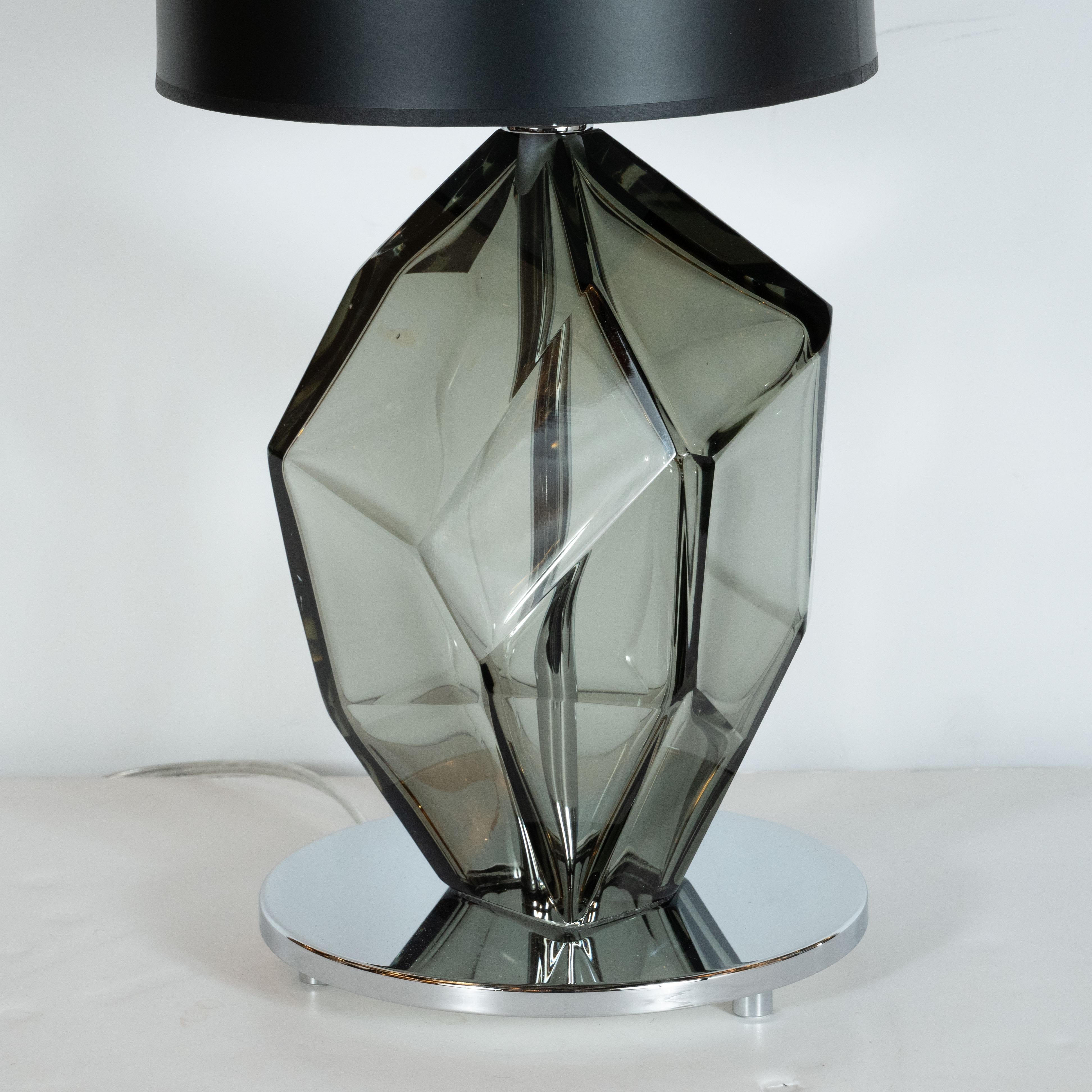 This stunning pair of modernist table lamps were hand blown in Murano, Italy the island off the coast of Venice centuries renowned for superlative glass production. Each lamp has a smoked pewter colored blown glass body that is shaped like an