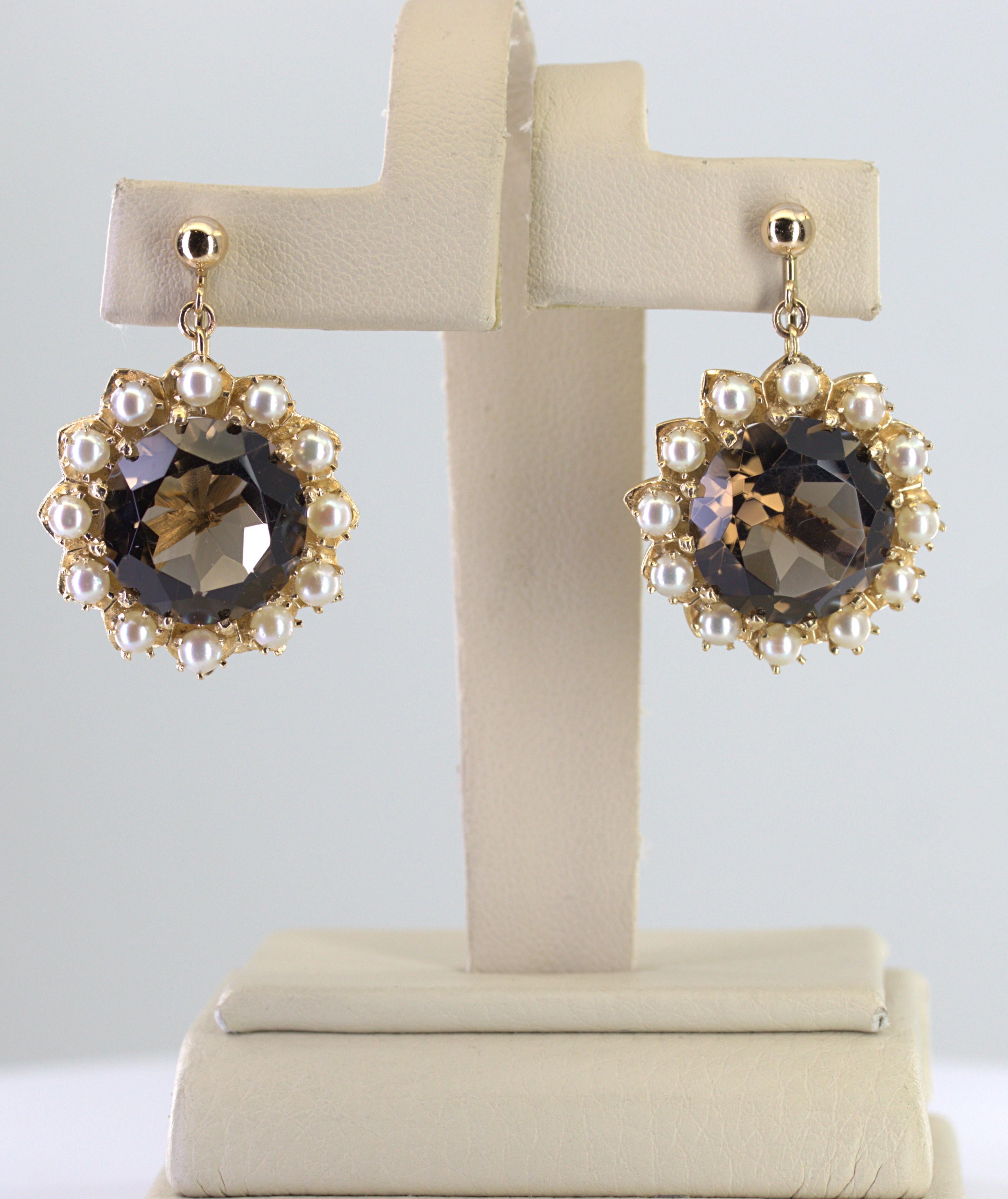 Featuring (2) round-cut smokey quartz, 10.00 cts. tw., surrounded by (24) round 3.6 mm cultured pearls set in a 14k yellow gold flower motif mounting, completed by a non-pierced screw back, 31.8 X 23.1 X 9.6 mm, marked 14K (backs), Gross weight