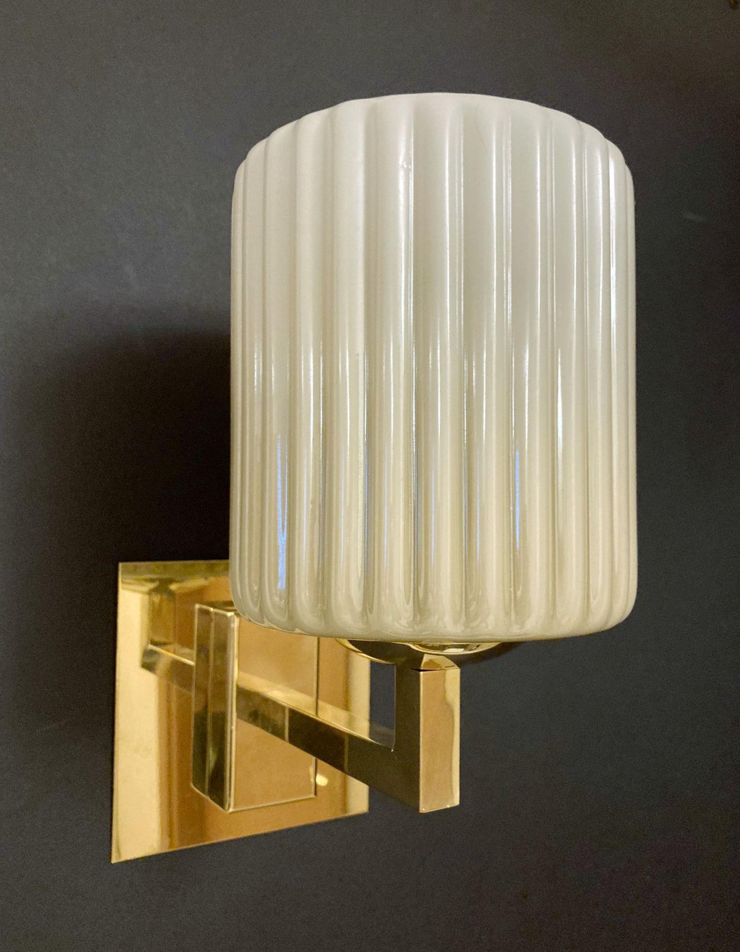 Italian wall lights with smoky ribbed Murano glass shades mounted on brass frames / Made in Italy by Barovier e Toso, circa 1950s
Original mark on the backplate
Measures: Height 10 inches, width 5 inches, depth 8 inches, backplate width 4.7 inches