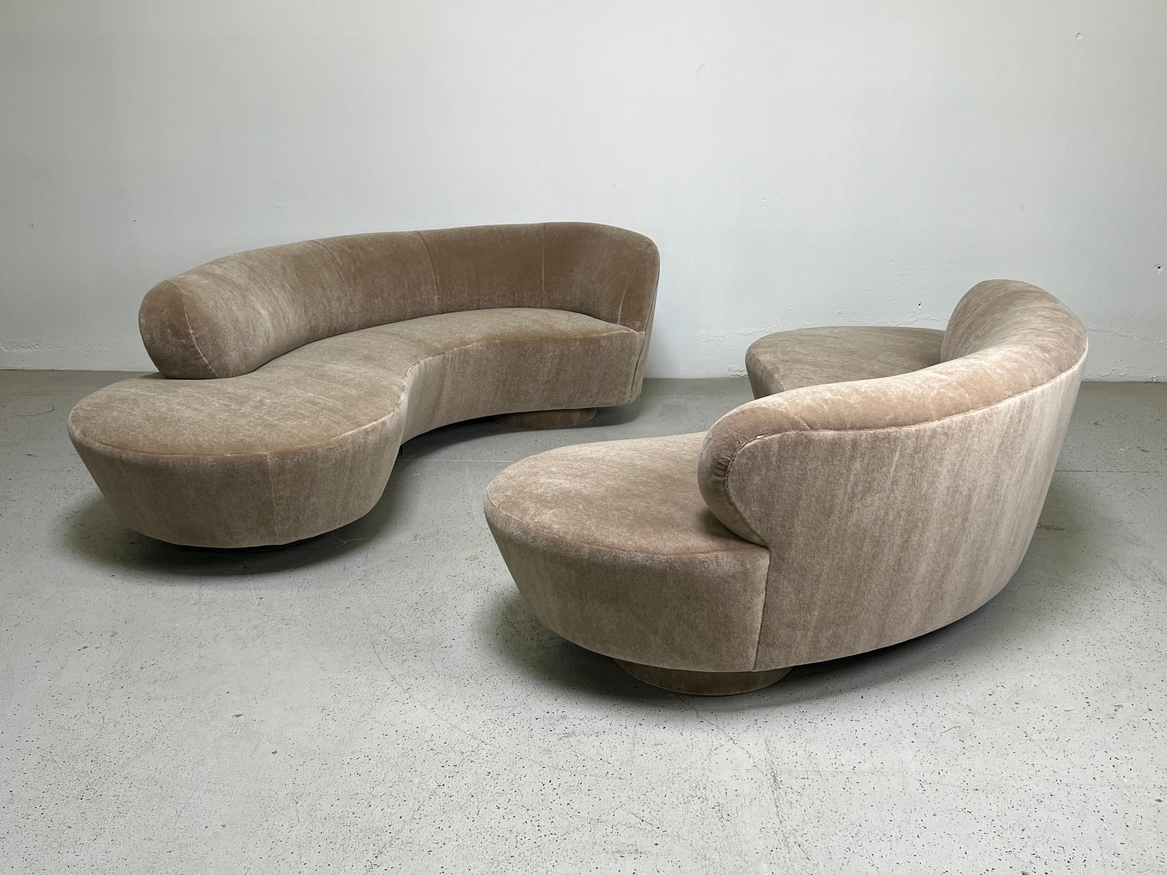 A pair of serpentine / cloud sofas designed by Vladimir Kagan for Directional. Fully restored and upholstered in Holly Hunt / Fuzzy Wuzzy / Honey Bear plush mohair.