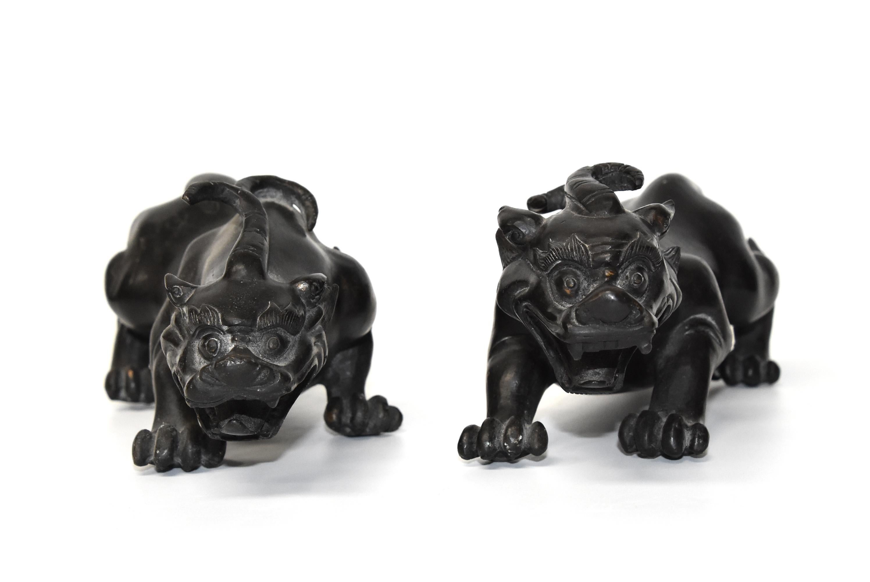 A pair of heavy, substantial bronze Pi Xiu beasts. These animals are mythical beasts believed to bring and keep wealth and good fortune. The artistry and craftsmanship is fantastic, depicting their ribs and muscles clearly and realistically. The