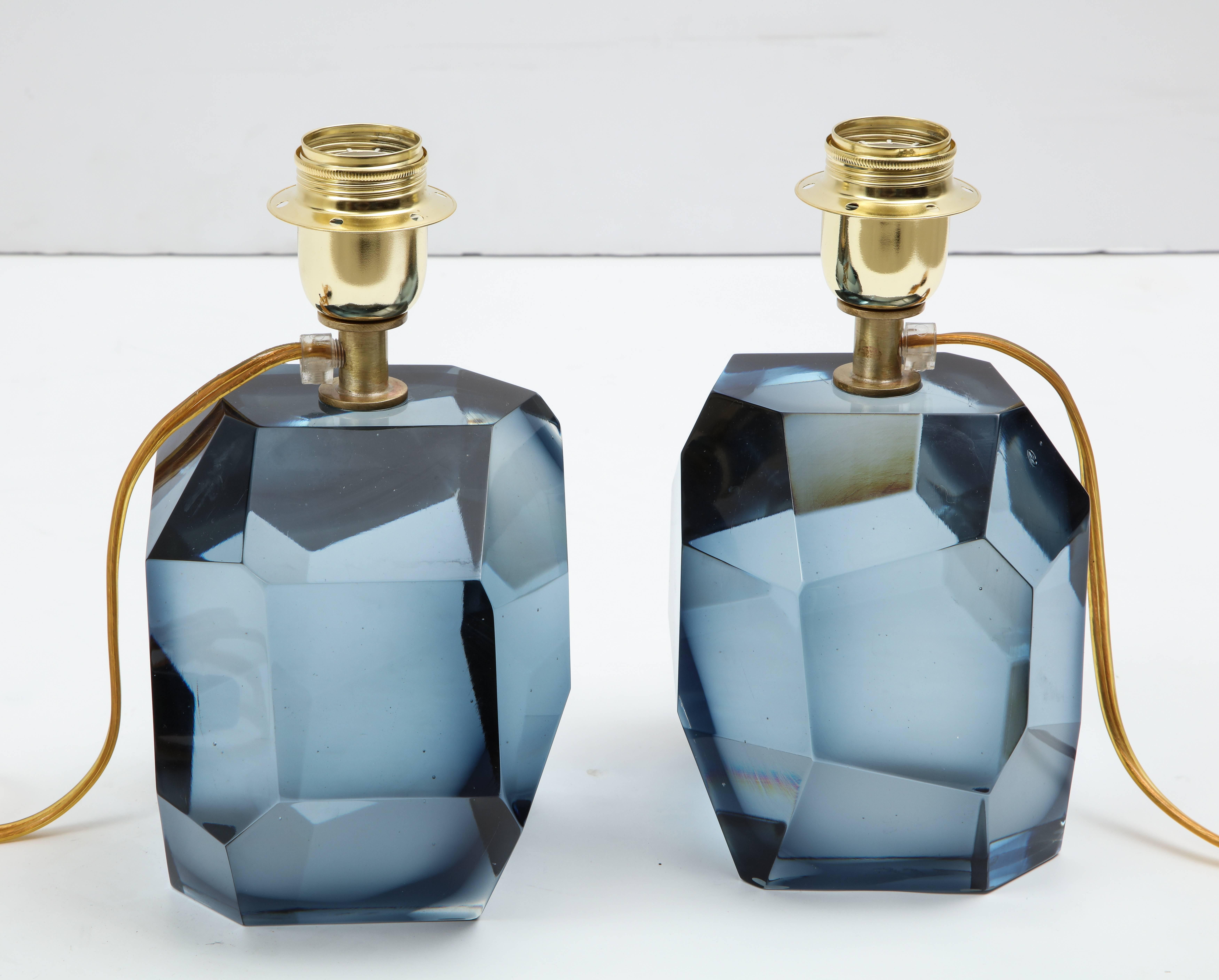 Unique pair of solid faceted Murano glass table lamps in an elegant blue grey color in the style of Roberto Rida with a gold tone/brass armature heavy and solid. Signed by the Murano Glass Master Alberto Dona/Murano. Made by hand in Murano, Italy.