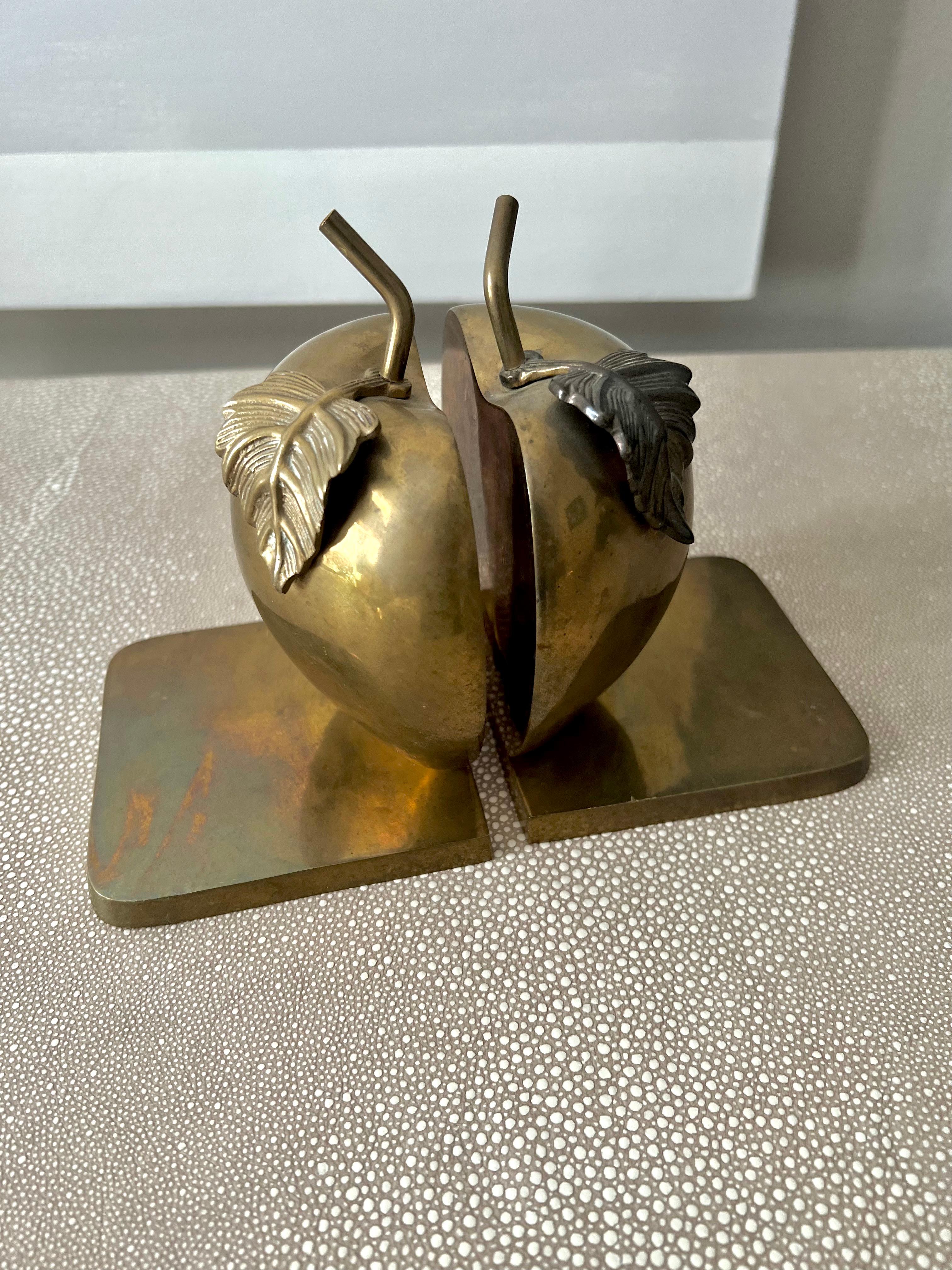 Pair of Brass Bookends that make up an apple and leaves.  The piece is a compliment to many spaces - any bookshelf, and especially those in the kitchen, work station or Childs room.

The patinated quality of the brass is phenomenal, however, with a