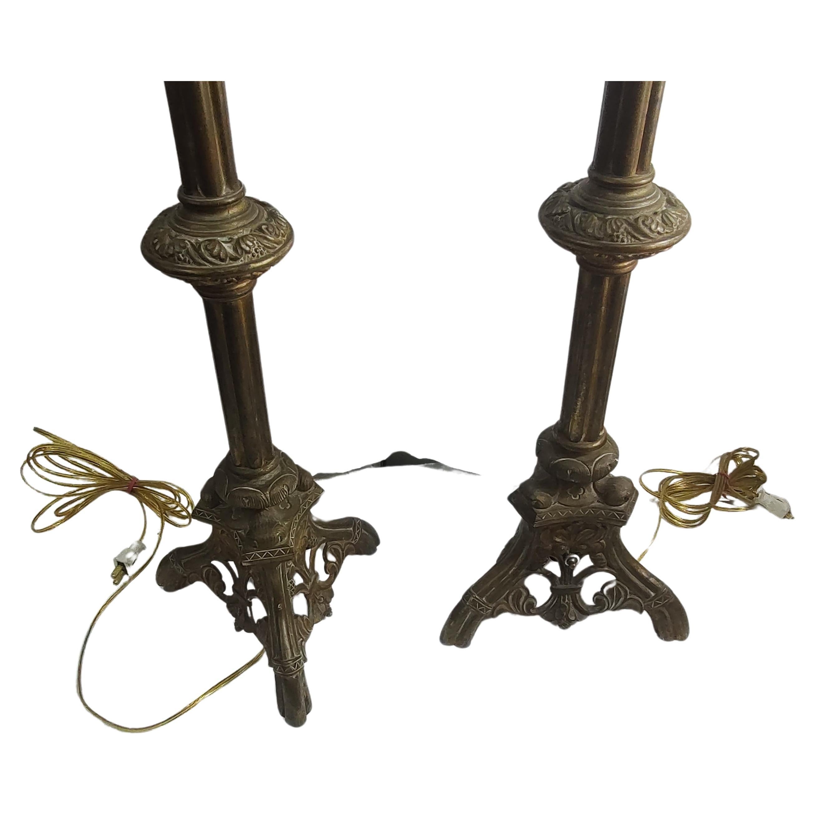 Beautiful pair of tall solid brass Ecclesiastical Edwardian style candlesticks converted to table lamps over 50 years ago and just recently revived with new wiring and double sockets. Great brass castings, heavy weight for stability. Sold as a set.