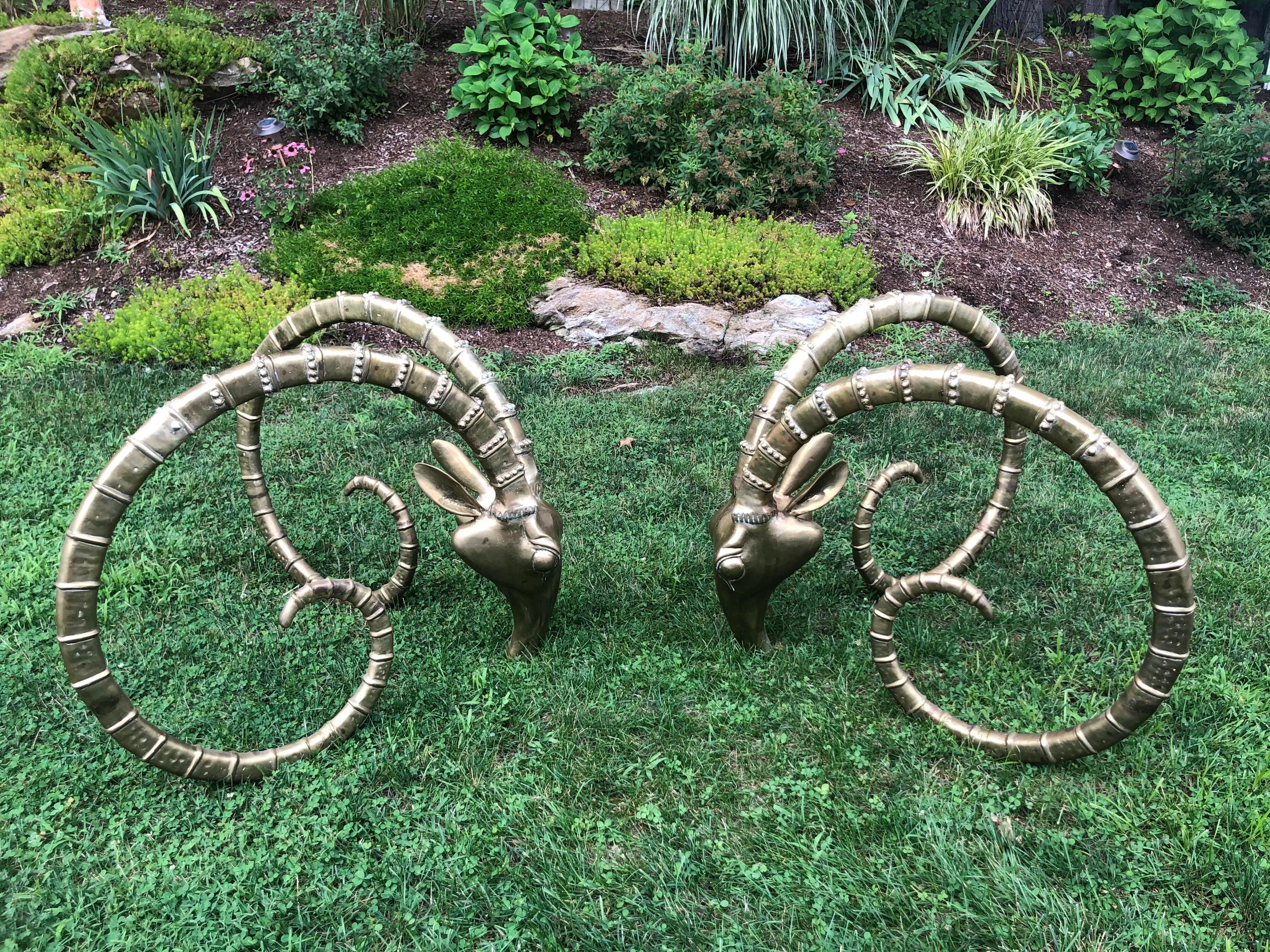 Pair of solid brass ibex Ram head dining table bases in the style of Alain Chervet. Intricately detailed these designer pieces make quite a statement. Just needs a glass top to your specs to be complete. These can also make an amazing desk. Price is