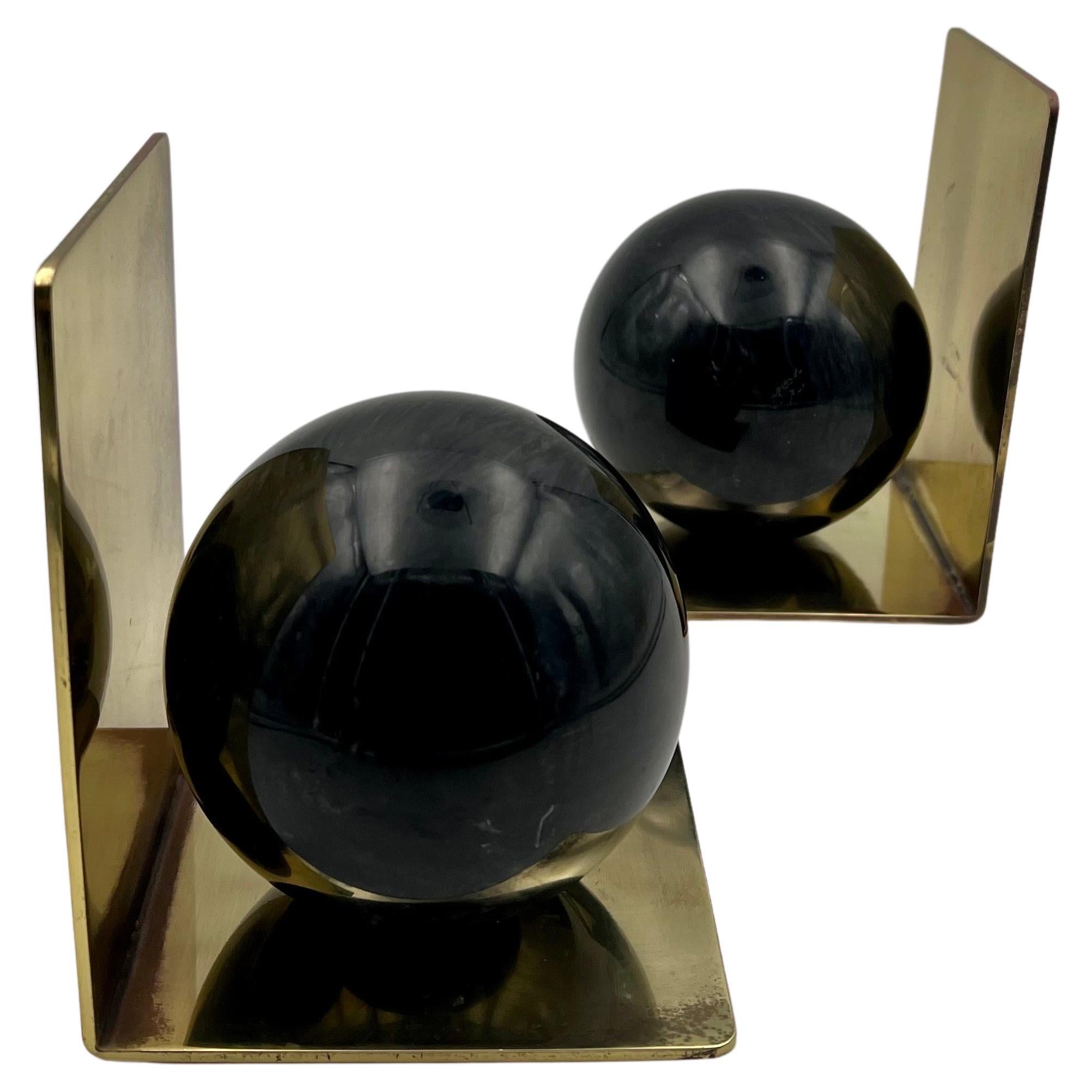 fabulous pair of solid patinated brass with beautiful solid black marble ball, circa 1980s great for Memphis decor.