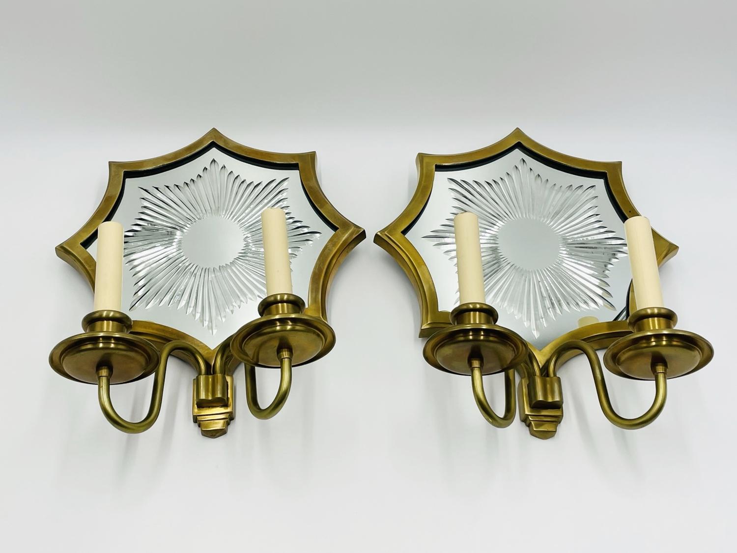 Beautiful pair of two armed sconces attributed to E. F. Caldwell in solid brass with wonderful vintage starburst mirror is sure to make a wonderful addition to your deÌcor.

Measurements:
16 inches high x 12.50 inches wide x 6 inches