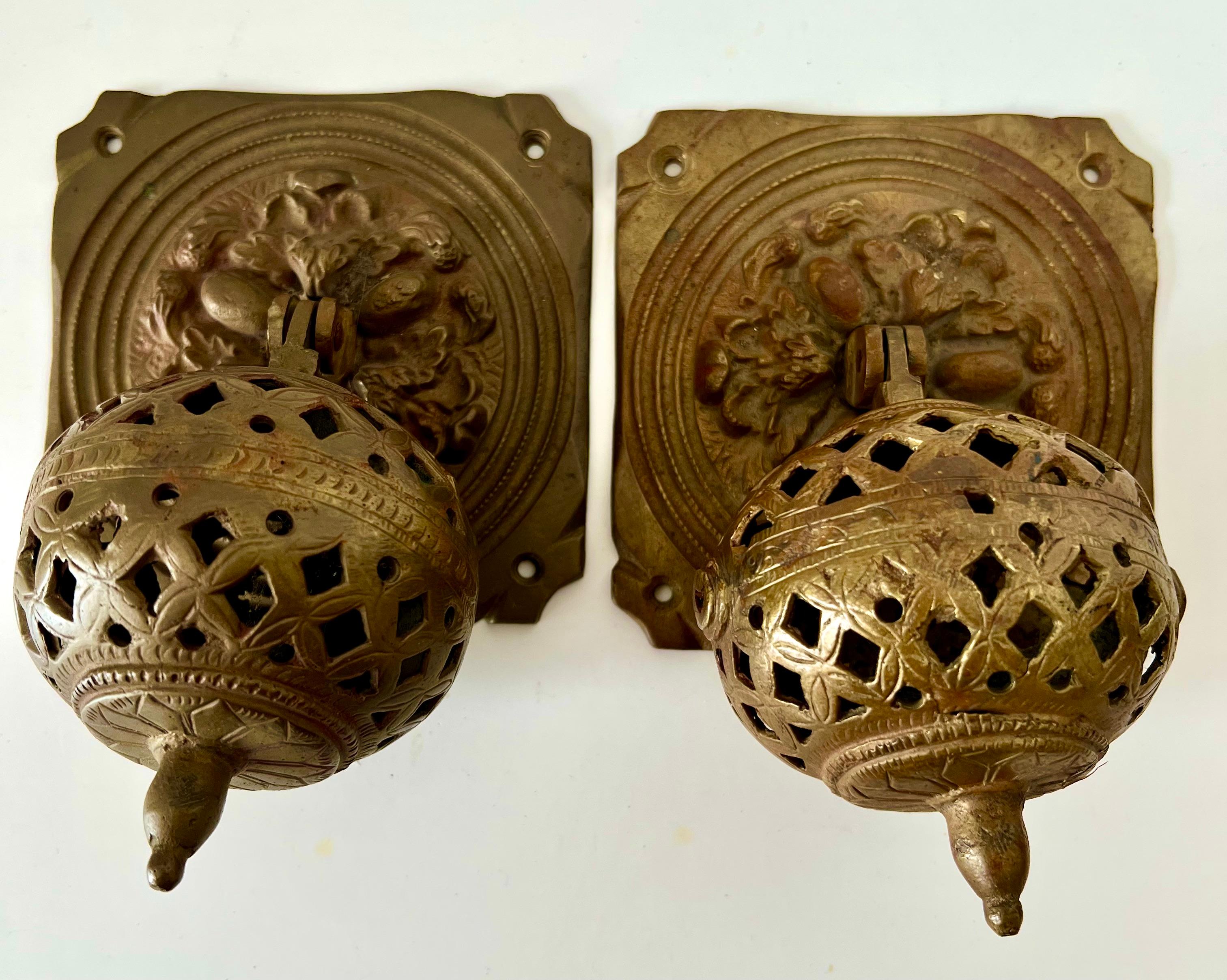 A pair of Moroccan / Moorish style door pulls or handles.  The pair are unique spheres intricately made and designed.   There were used at a design space and found prior to that in an estate sale.

Solid Brass and really wonderfully designed and a