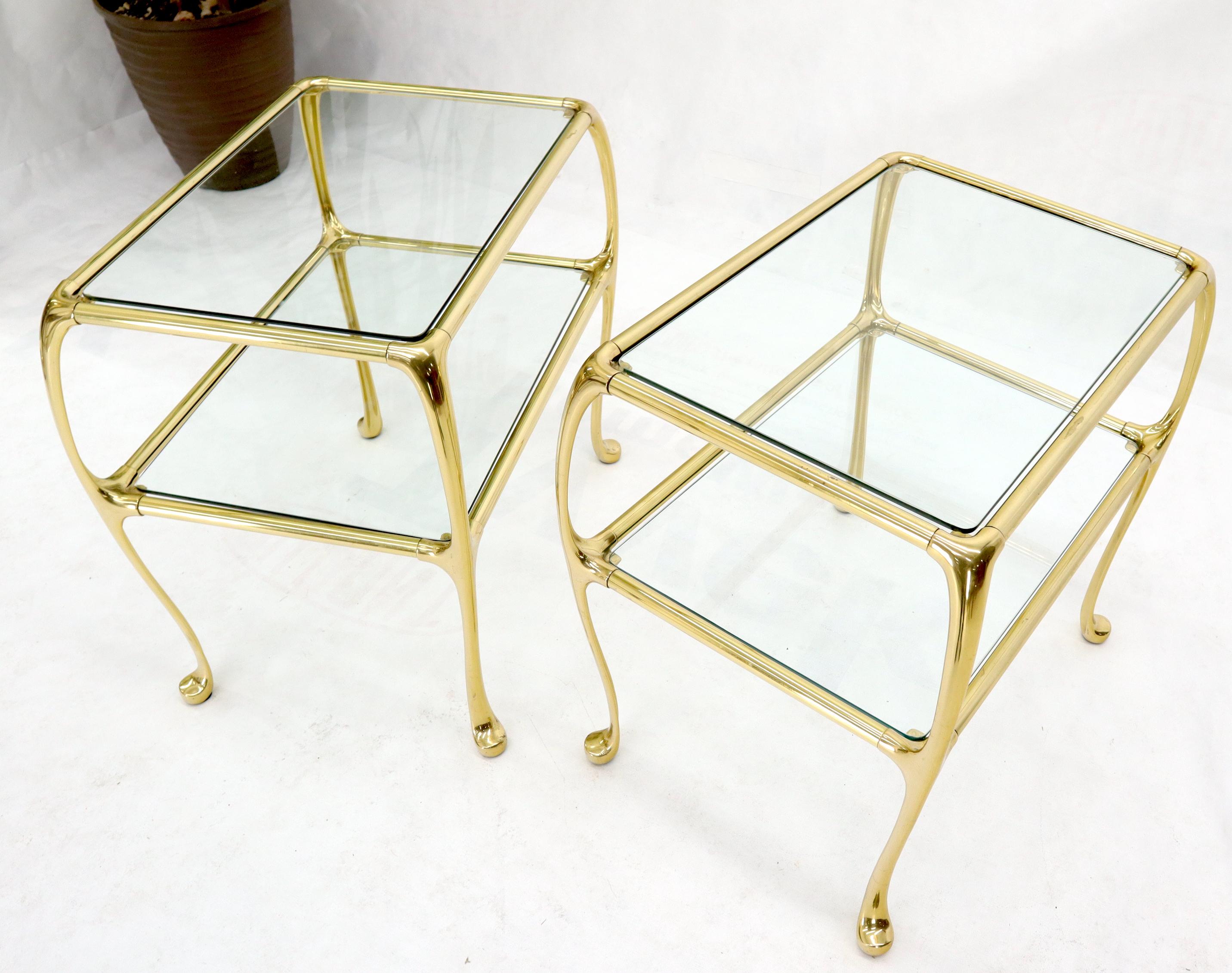 Pair of forged solid brass end side tables with glass tops.
