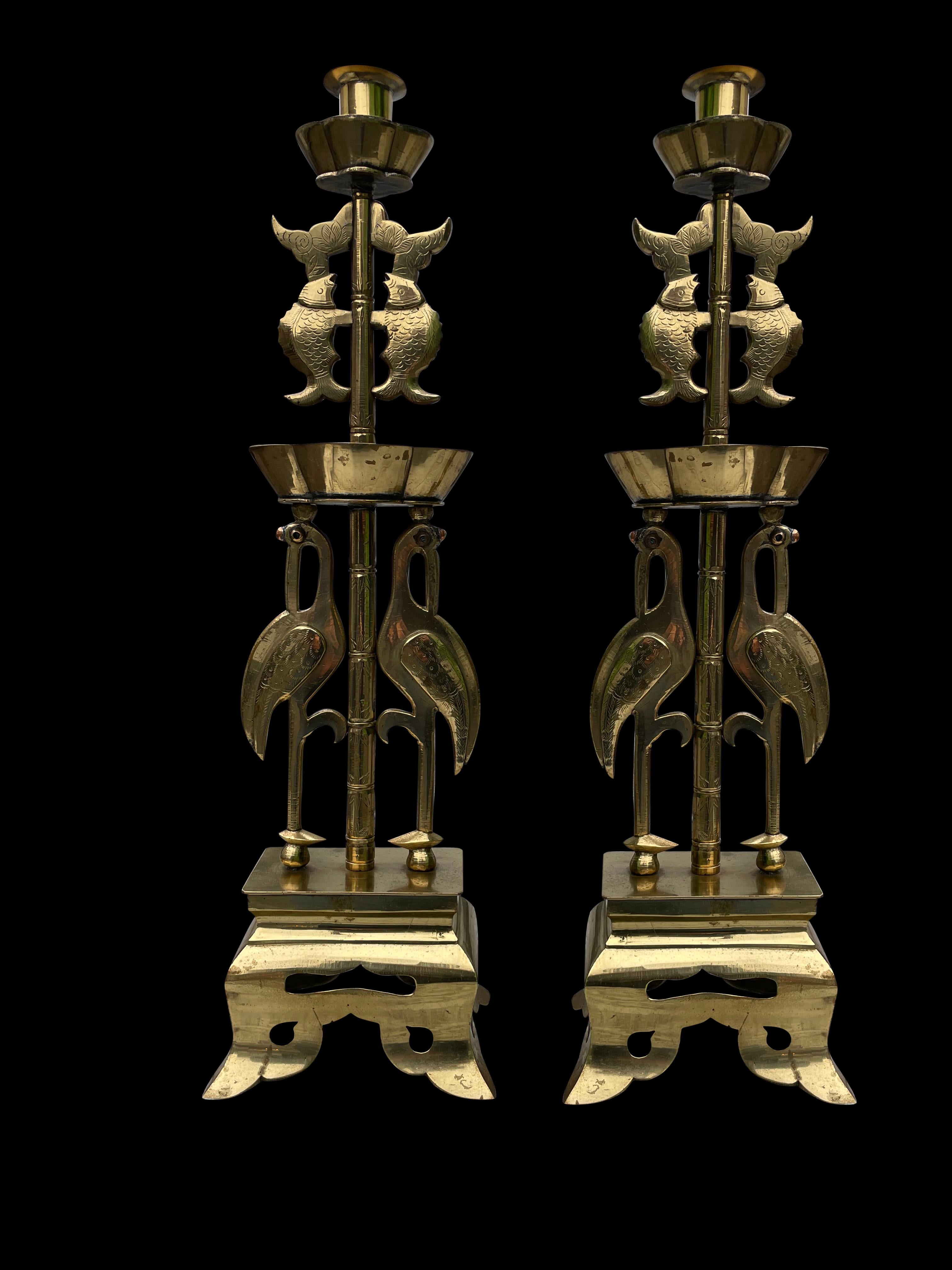 A superb pair of solid brass oriental Arts & Crafts style candlesticks, 20th century.