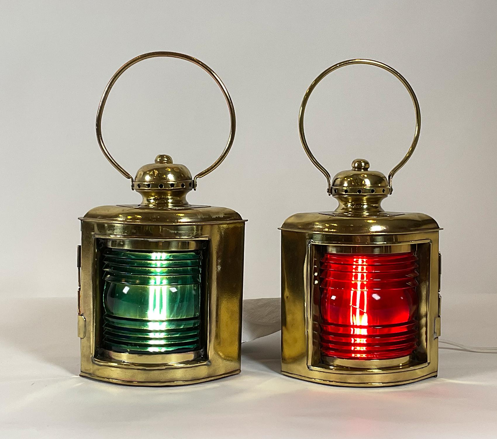 Fabulous pair of ship’s lanterns with cut glass Fresnel lenses. One is a deep ruby lens, the other a rich blue. The port lantern has a brass badge reading port classes II & III, the starboard also. The doors are engraved with maker’s name National