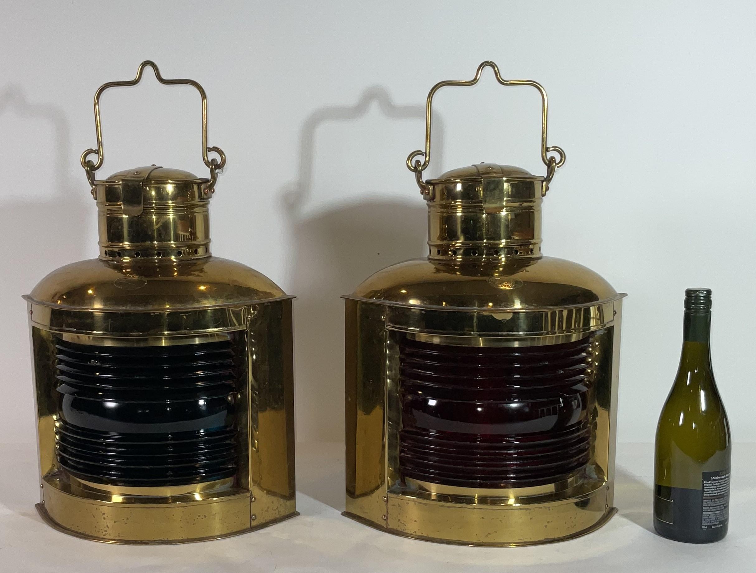 Highly polished solid brass ships port and starboard ships lanterns with fresnel glass lenses. Warm lacquer finish. With Brooklyn makers tags from Perkins Marine Lamp Corporation, 