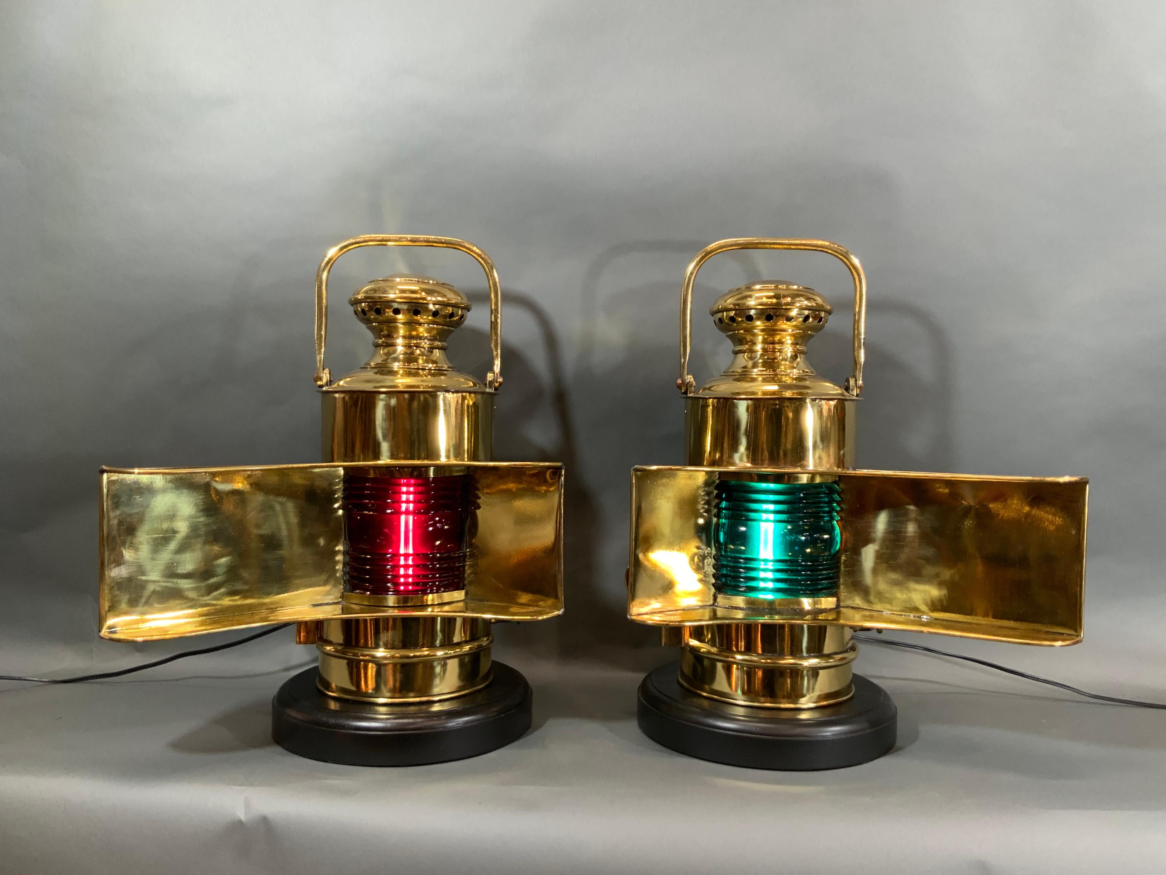 U.S. Navy pair of “wing to wing’” bridge lanterns from the early twentieth century. They have been stripped of the military paint and meticulously polished and lacquered. The long vanes are striking. Very sturdy with hinged rear doors. Both have