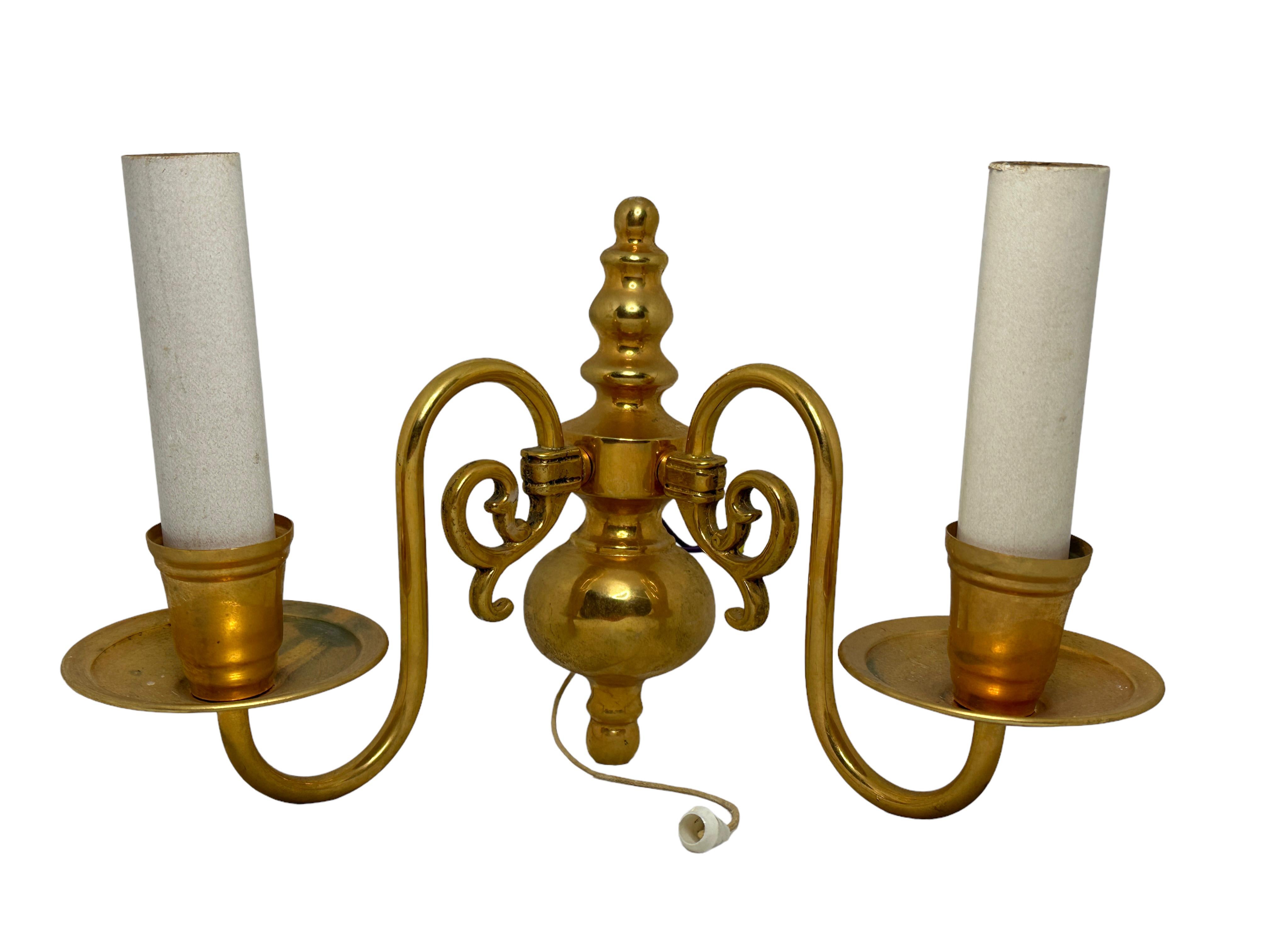 A stunning pair of heavy brass wall sconces. Each consisting of a stylish Farmhouse style design. Each fixture requires two European E14 / 110 Volt candelabra bulbs, each bulb up to 40 watts. Light bulbs are not included in the offer. A nice