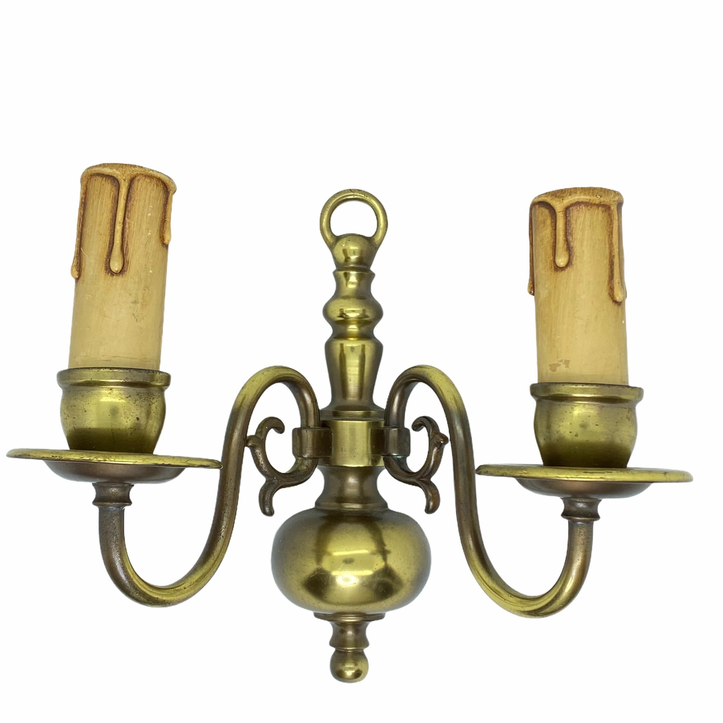 A stunning pair of heavy brass wall sconces. Each consisting of a stylish Farmhouse style design. Each fixture requires two European E14 / 110 Volt candelabra bulbs, each bulb up to 40 watts.