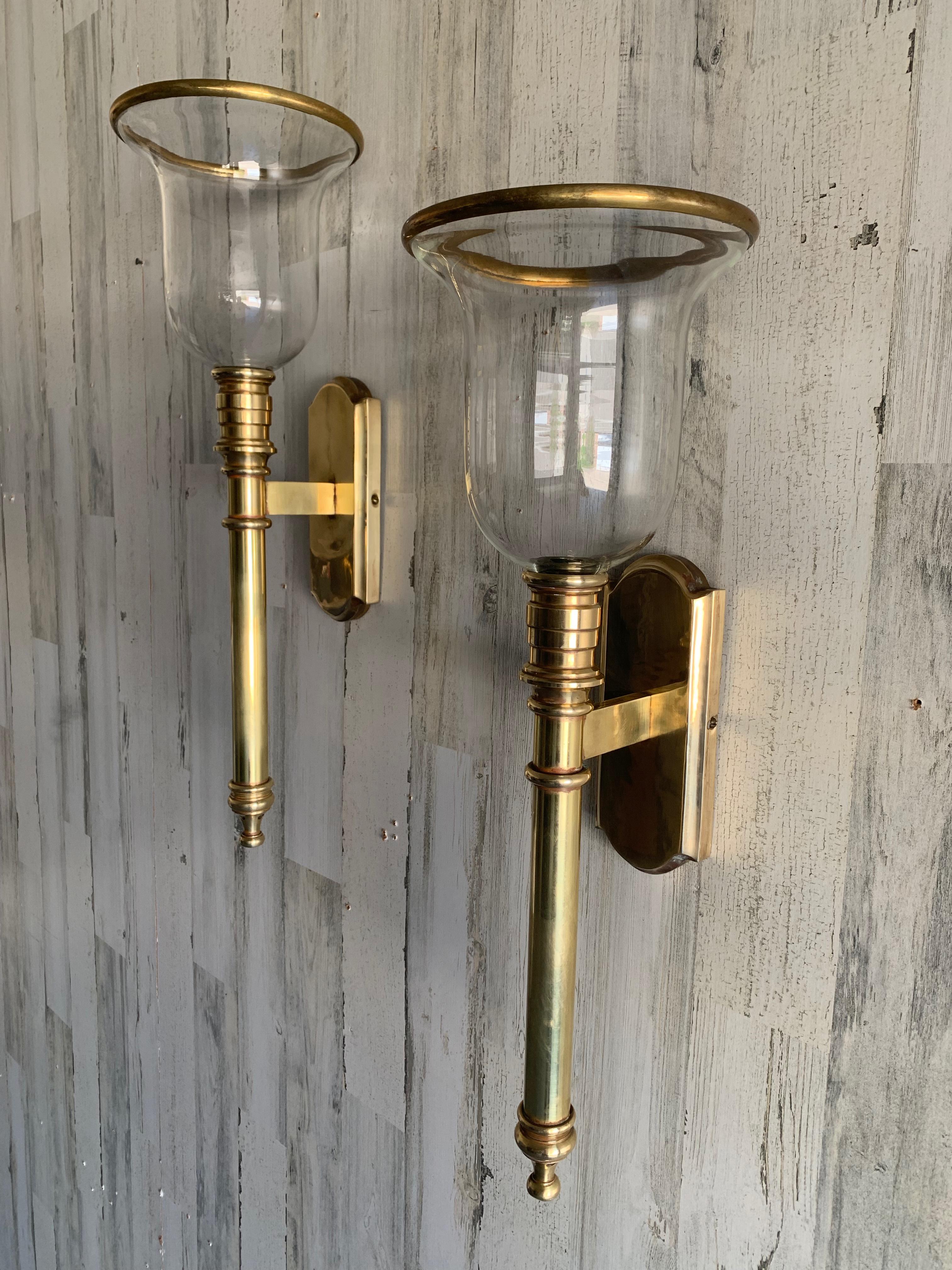 Solid brass candle sconces from Chapman Brass co. Inverted bell shaped glass with brass rim shade.
The sconces are very stately in their presence. 