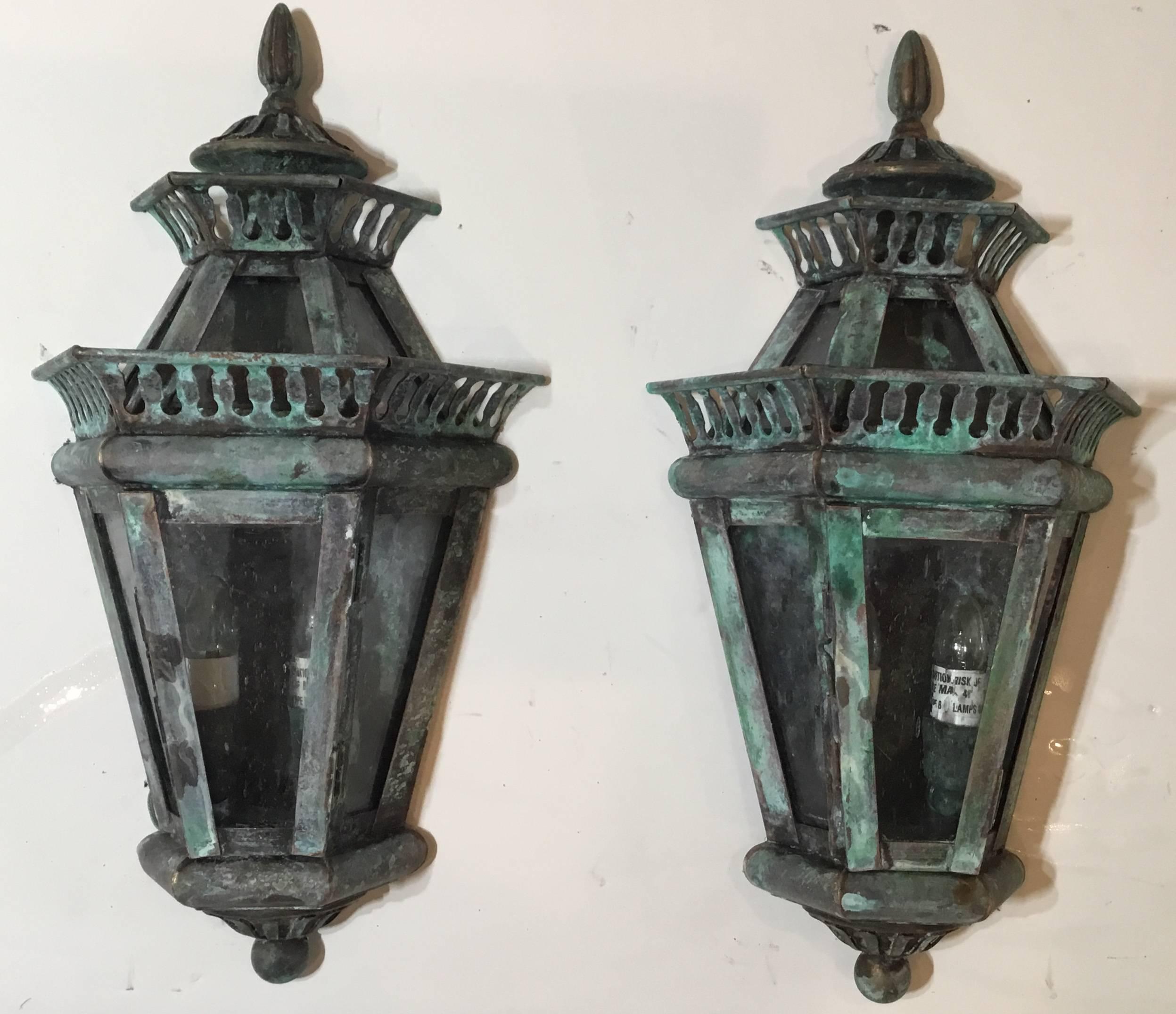 Decorative pair of lanterns handcrafted from solid brass with two 40/watt lights each, suitable for
Wet locations, up to US code UL approved.