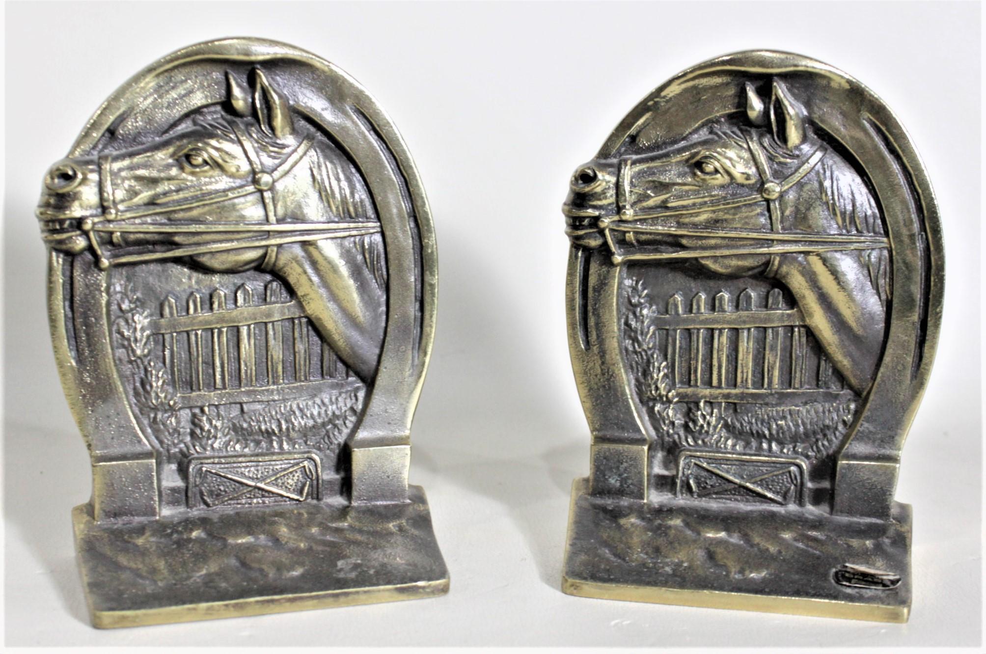 This pair of solid cast brass bookends was made by the Hohn manufacturing company of New Hampshire in approximately 1970. The bookends depict a silhouette of a horse's head with a picket fence in the background and bordered on the top by a horse