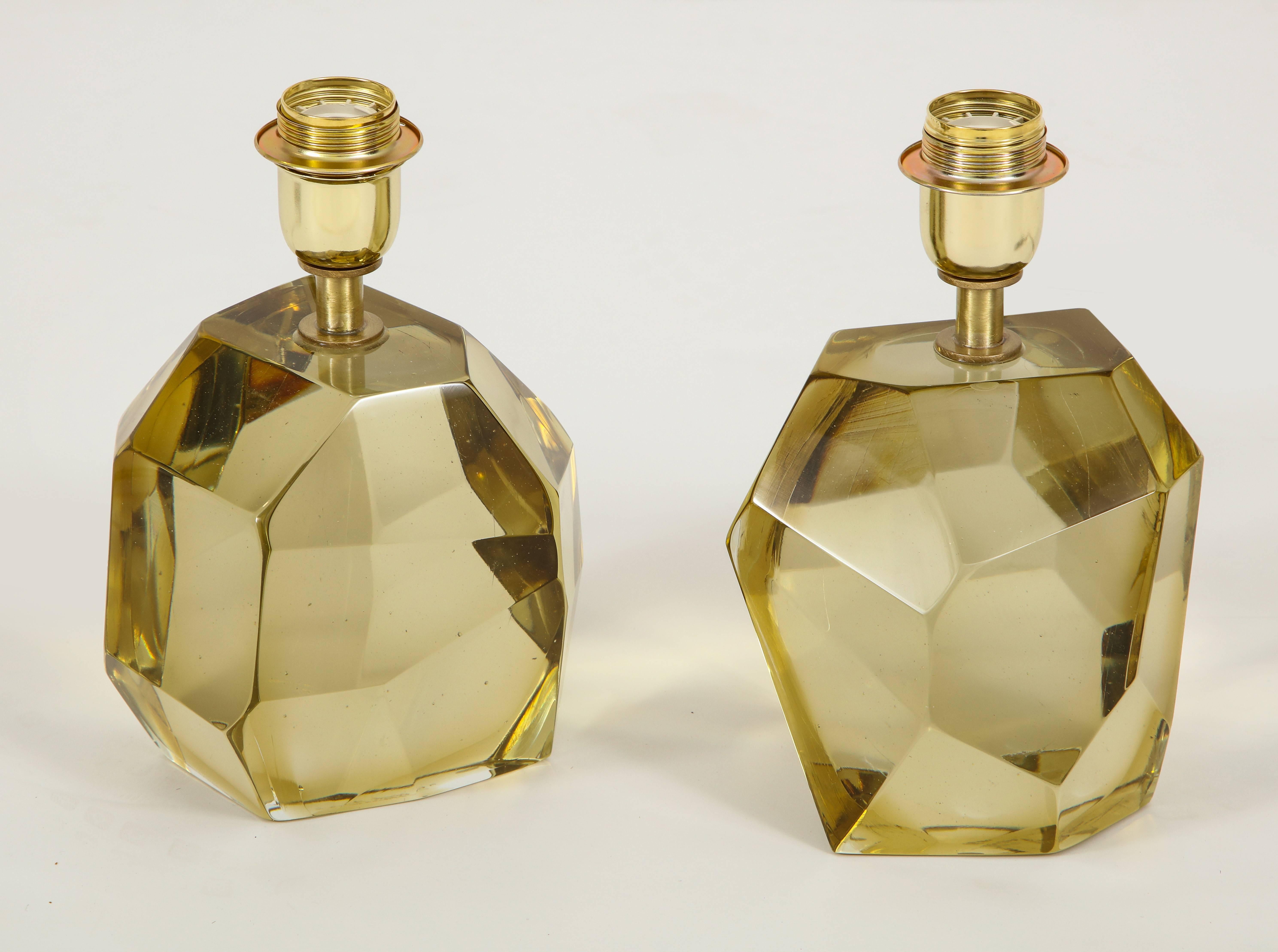 Unique pair of solid faceted Murano glass table lamps in a vibrant citrine or gold color with a gold tone/brass armature heavy and solid. Made by hand in Murano, Italy, by the Master Glass Maker, Alberto Dona. Wired for U.S. use. Height of 10