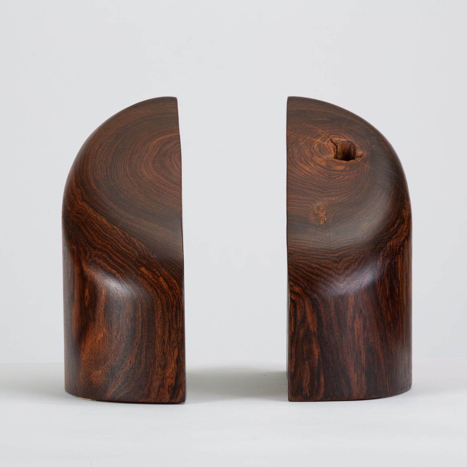 A pair of solid wood bookends by Mexican-American designer Don Shoemaker for his company, Señal. Rendered in highly figured cocobolo wood, a species of local tropical wood similar to rosewood, the bookends showcase a dynamic grain pattern and the