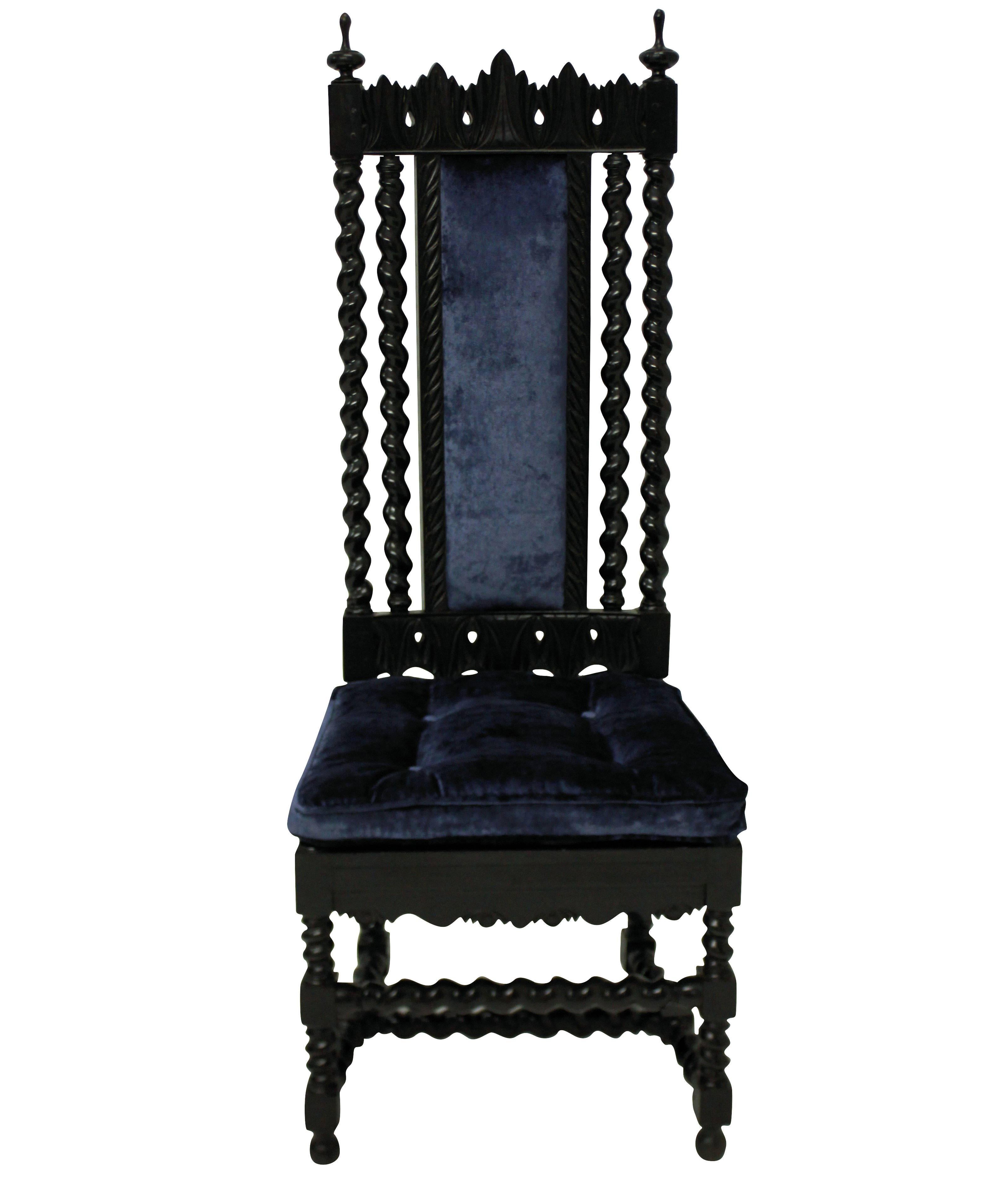 A pair of finely carved solid ebony Anglo-Indian high back hall chairs, with blue velvet upholstery.

 
