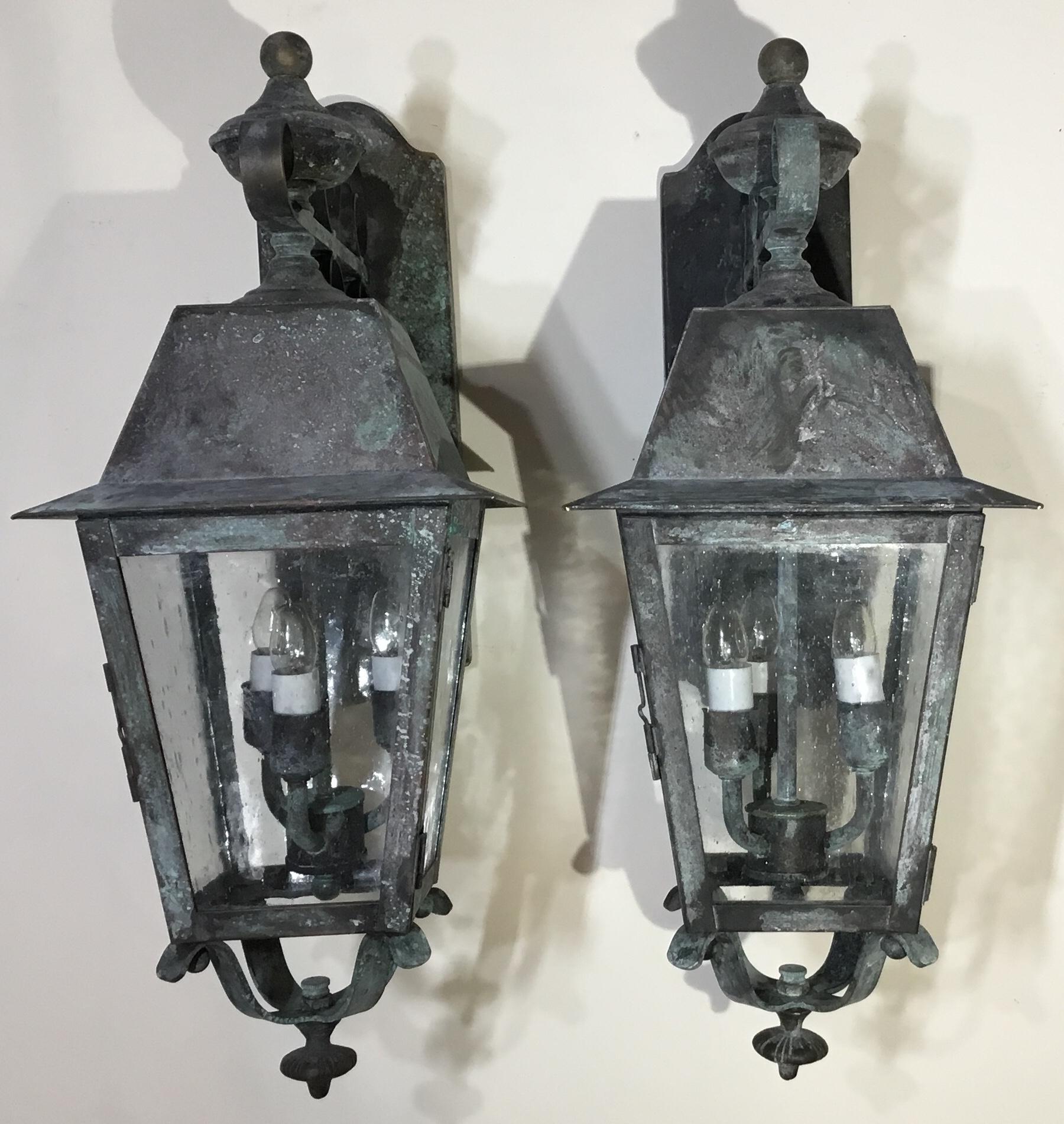 Elegant pair of lanterns made of solid brass with very decorative backplate support, three 40/watt
Lights each, seeded glass, electrified and ready to use, UL approved, up to US code, suitable for wet locations.