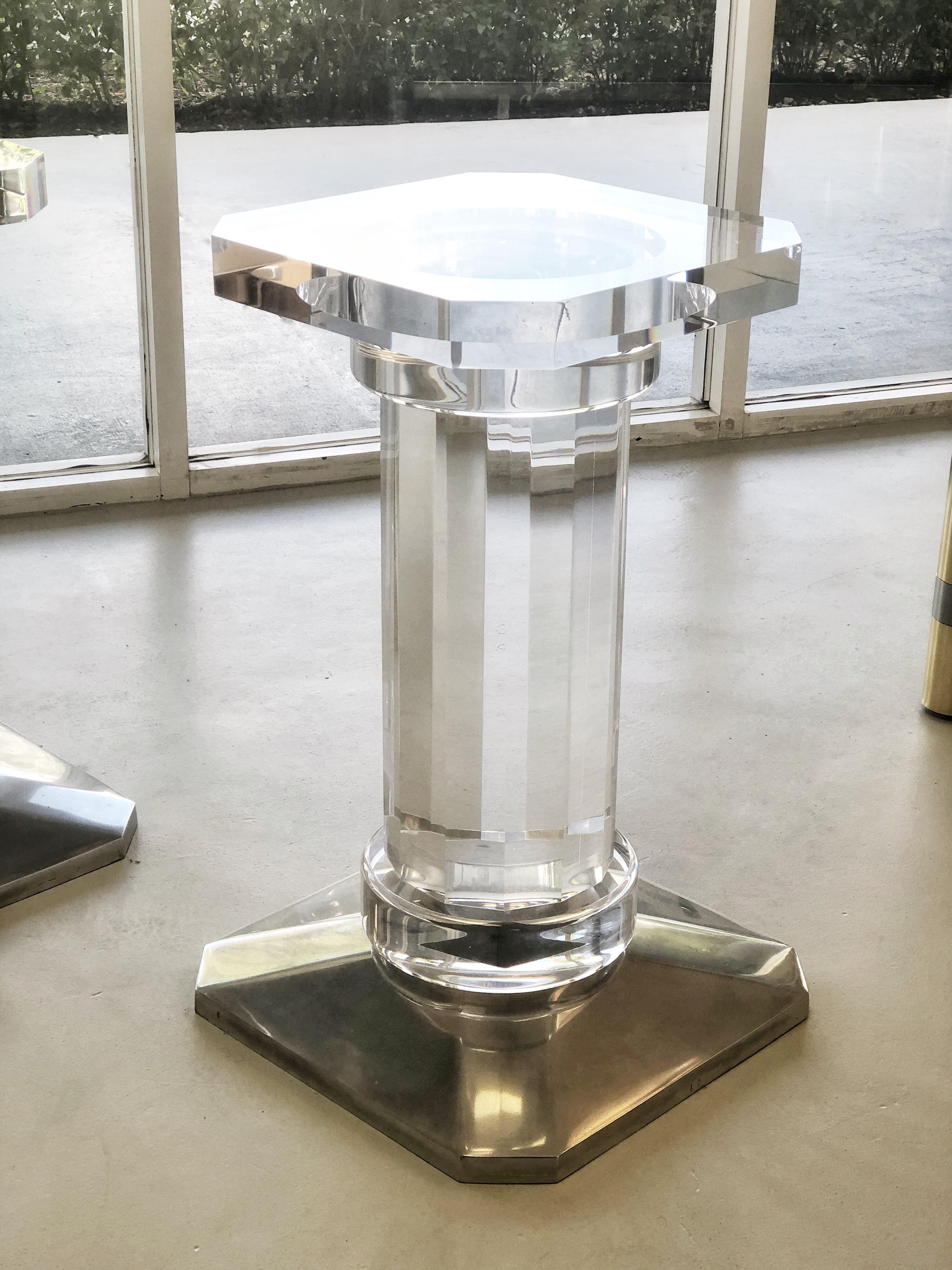 This is a pair of solid Lucite bases with polished aluminum elements for a dining or conference table. Very clear and crisp detail. Quite versatile as would work in any style.