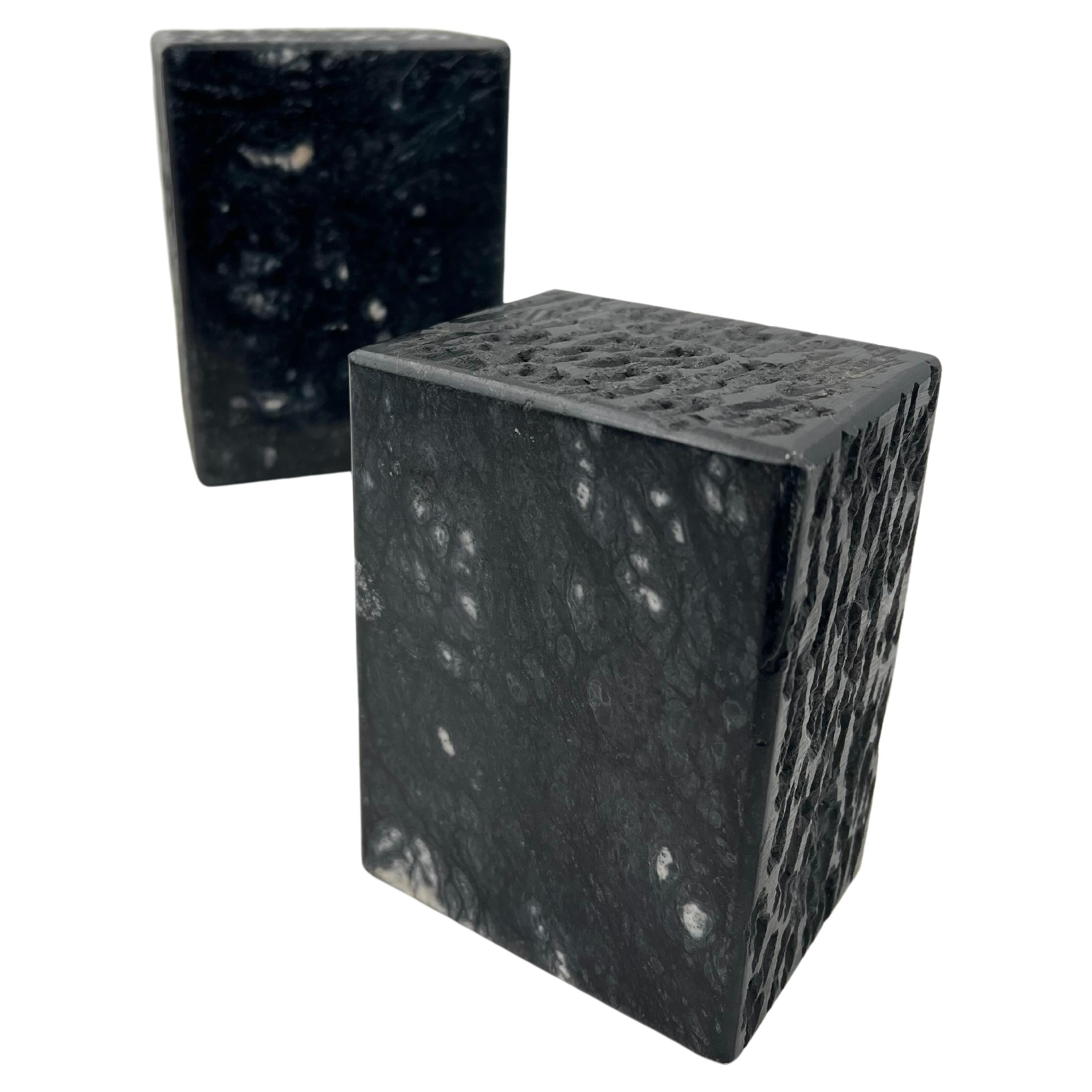 Pair of solid marble block bookends circa 1980s made in Italy with 4 sides textured finish and one side polished, in black marble.