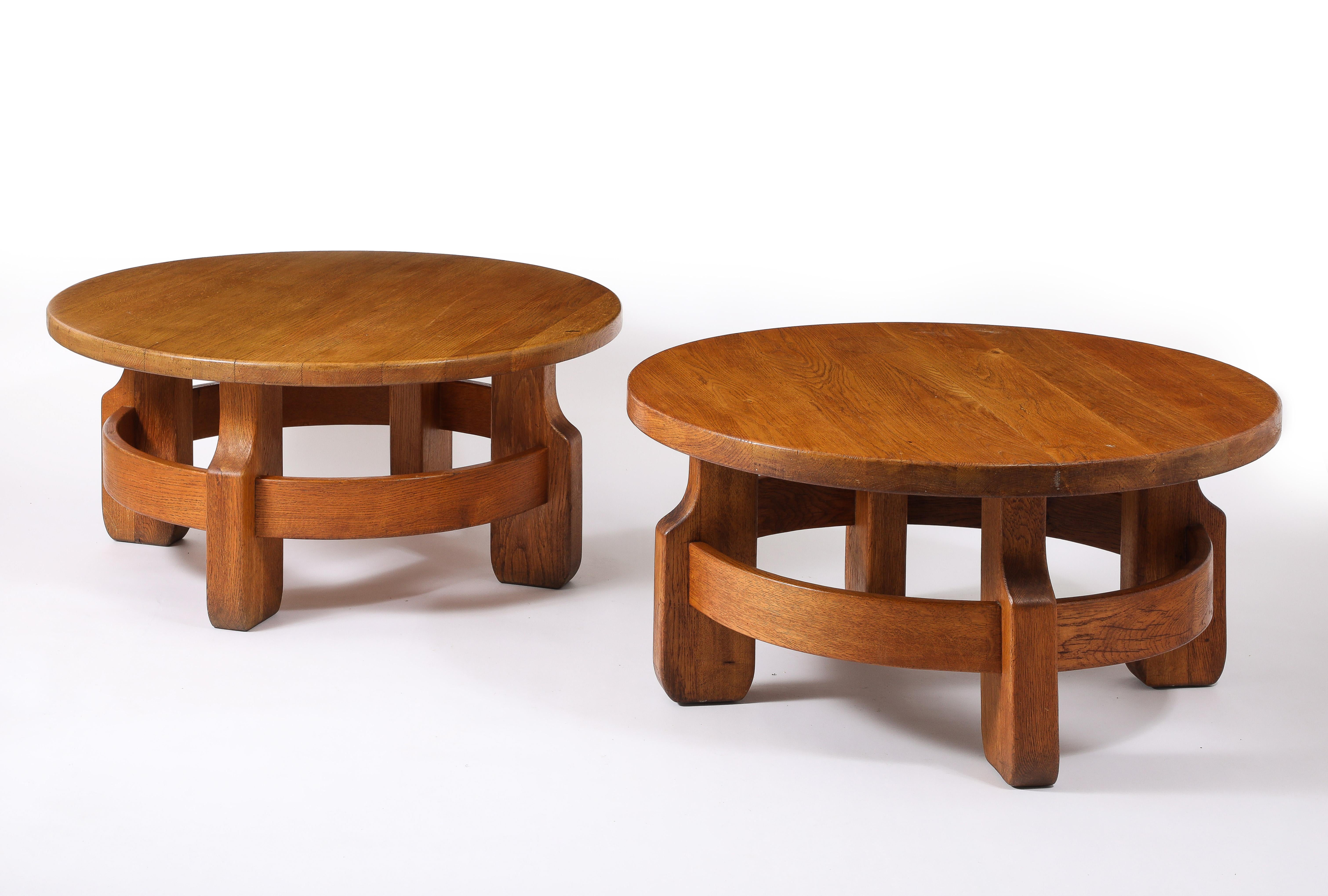 Matched pair of oak coffee tables, solid tops on large baluster feet linked by a circular oak band, a very unusual design. Sold as a pair or a single.