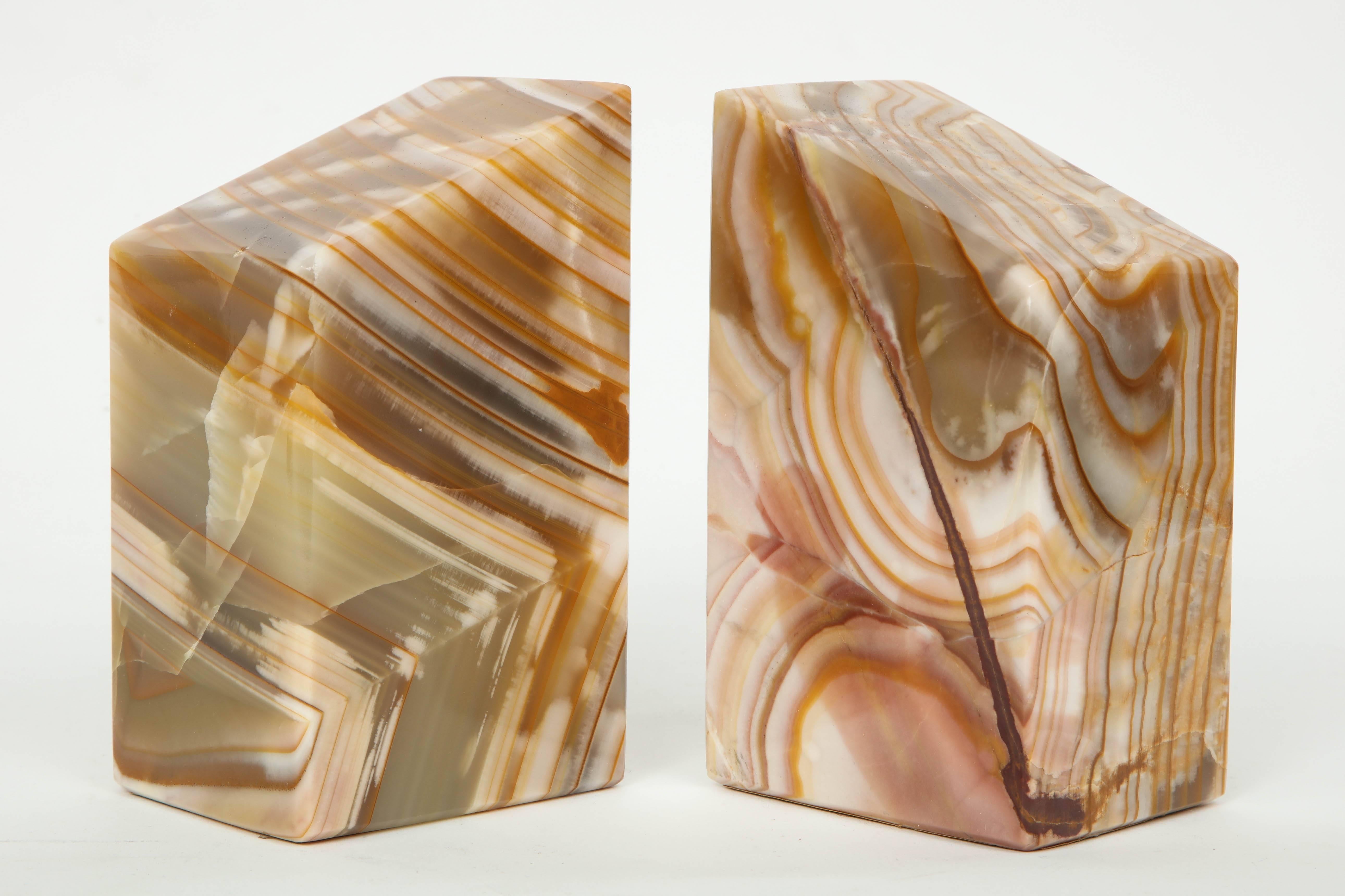 Modernist pair of solid onyx stone bookends in an earth tone pallette.