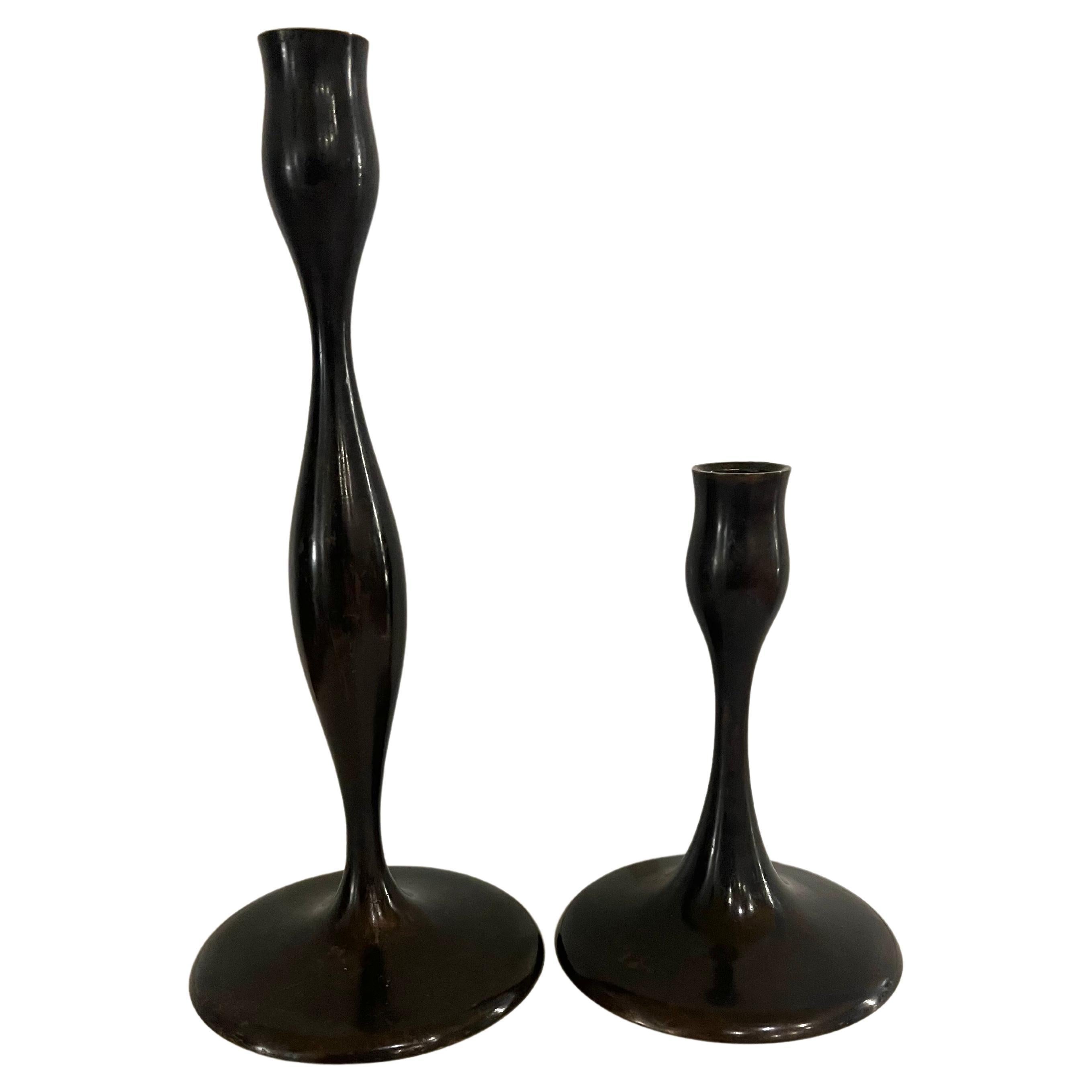 Great pair of solid bronze sculptural candle holders, by Eva Zeisel, in nice condition and patina. the tall is 11