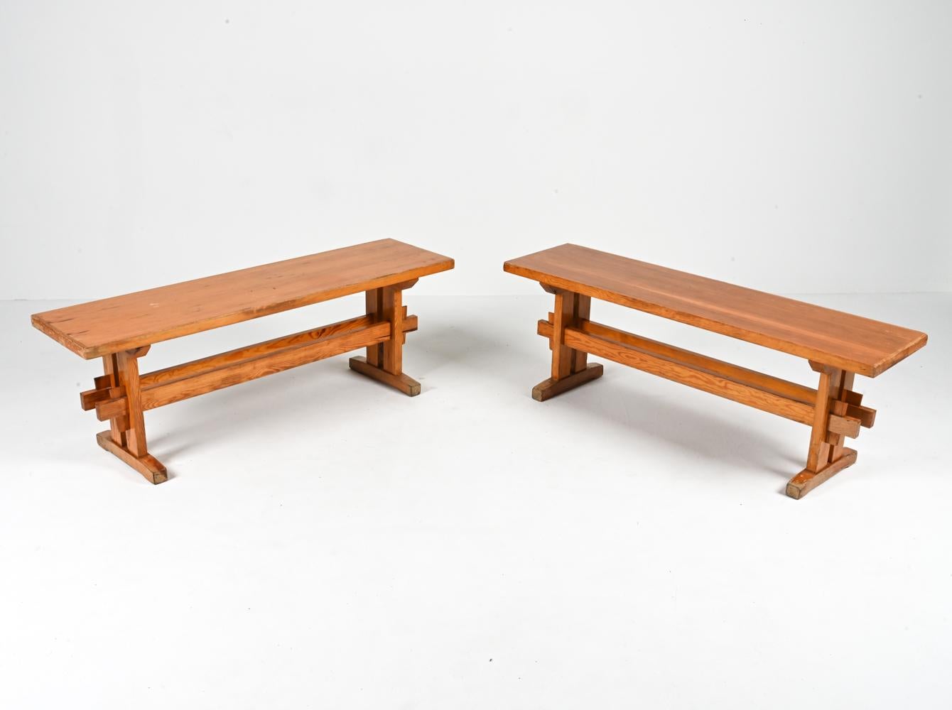 Embrace the perfect marriage of Scandinavian Modernism and rustic charm with this remarkable pair of solid pine benches. Attributed to Sven Larsson, a celebrated name in the world of furniture design, these benches effortlessly blend form and