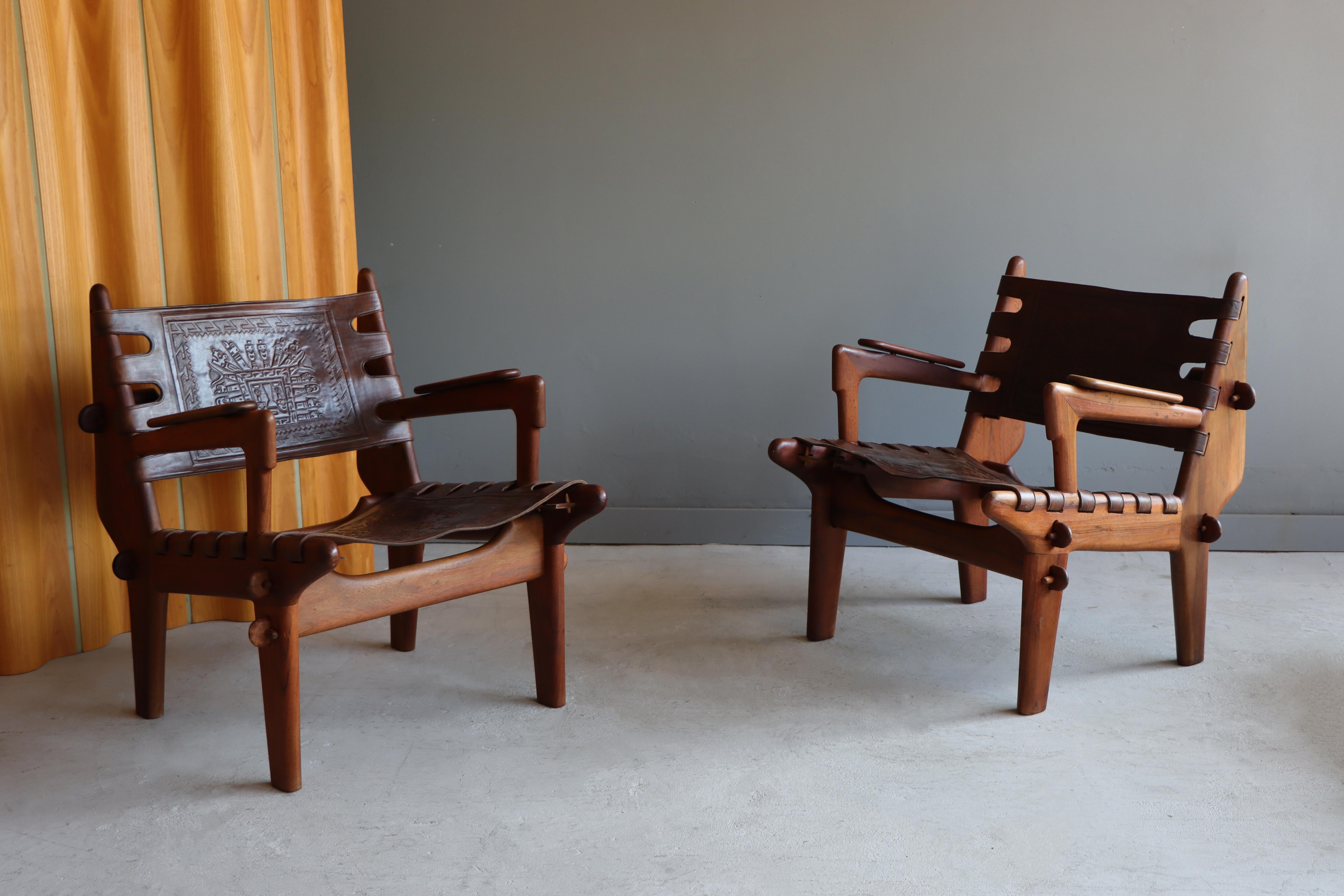 Beautiful pair of lounge chairs designed by Angel Pazmino for Muebles De Estilo, Ecuador, circa 1960s. 

Both chairs are constructed of solid rosewood and thick leather. The leather is fixed with wooden stakes and each portion of the frame is