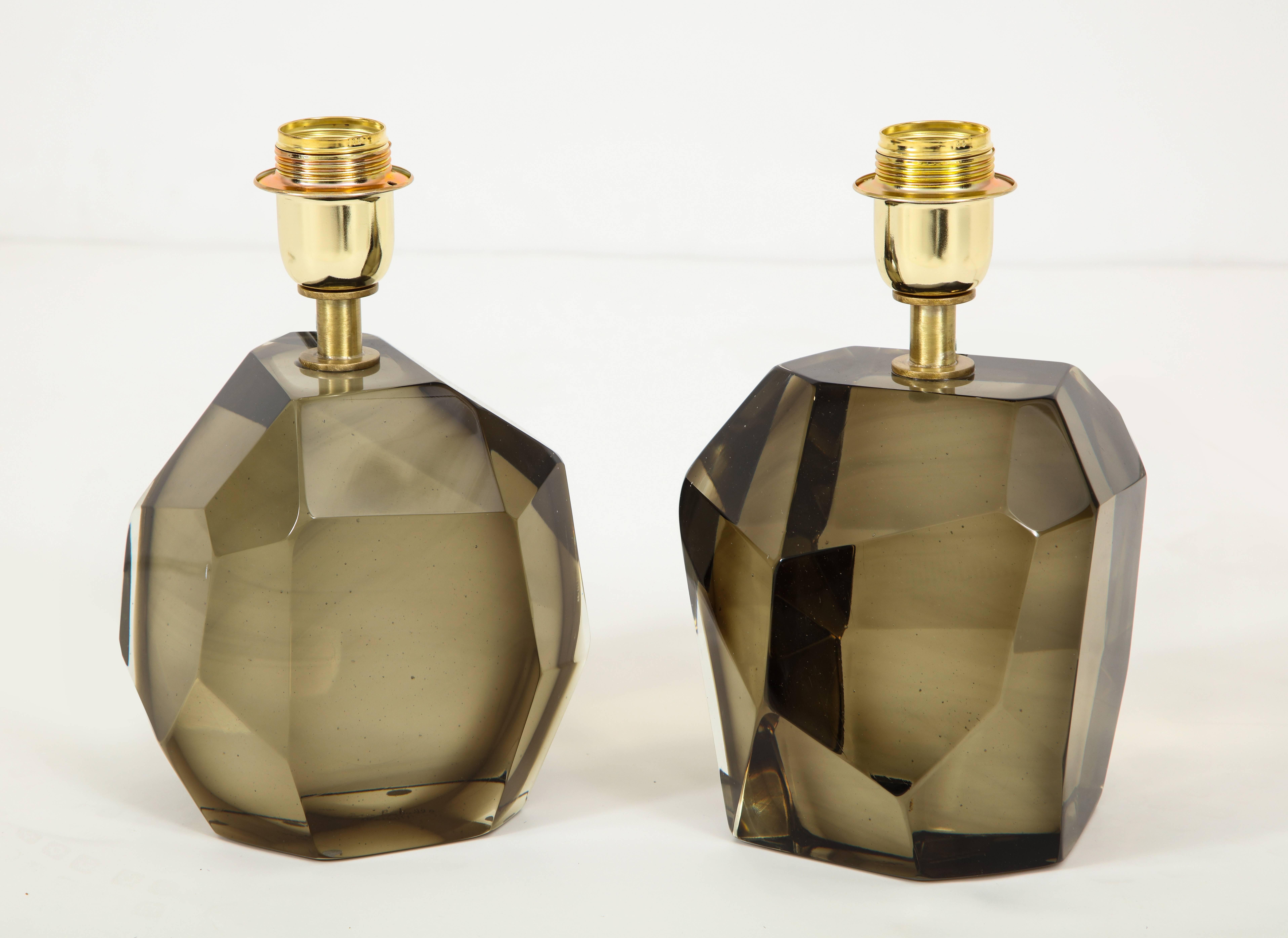 Unique pair of solid faceted Murano glass table lamps in an elegant Smokey taupe or bronze color with a gold tone/brass armature heavy and solid. Made by hand in Murano, Italy. Wired for U.S. use. Height of 10