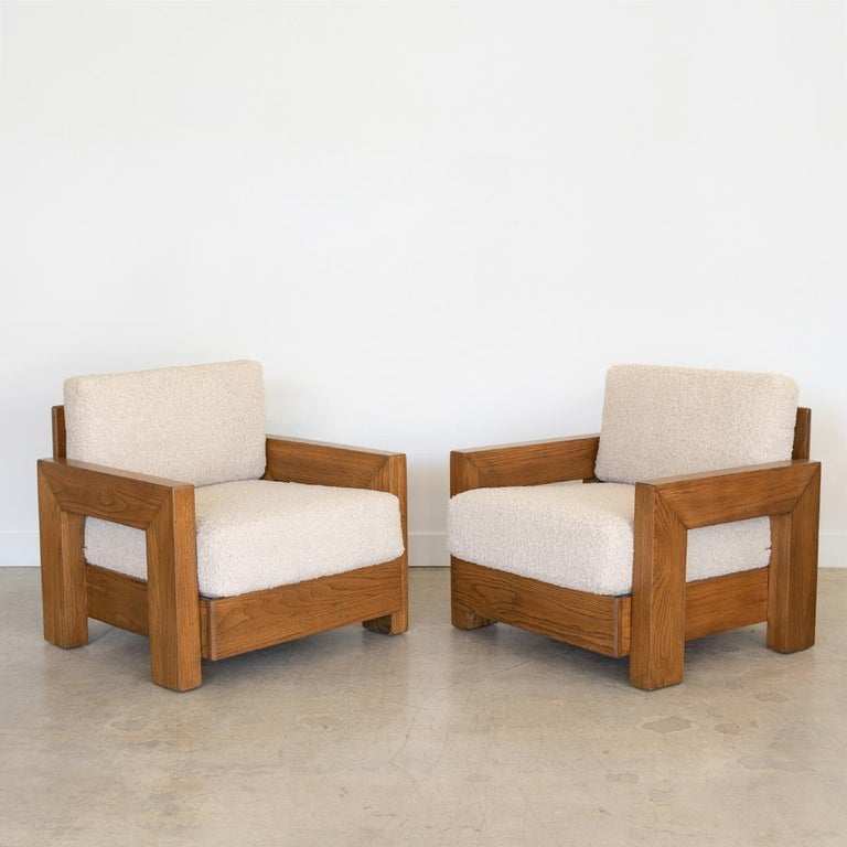 Great pair of heavy solid wood club chairs from the USA, 1970's. Cube wood frame has been newly refinished and cushions newly upholstered in a creamy poodle fabric. Beautiful details from all angles.