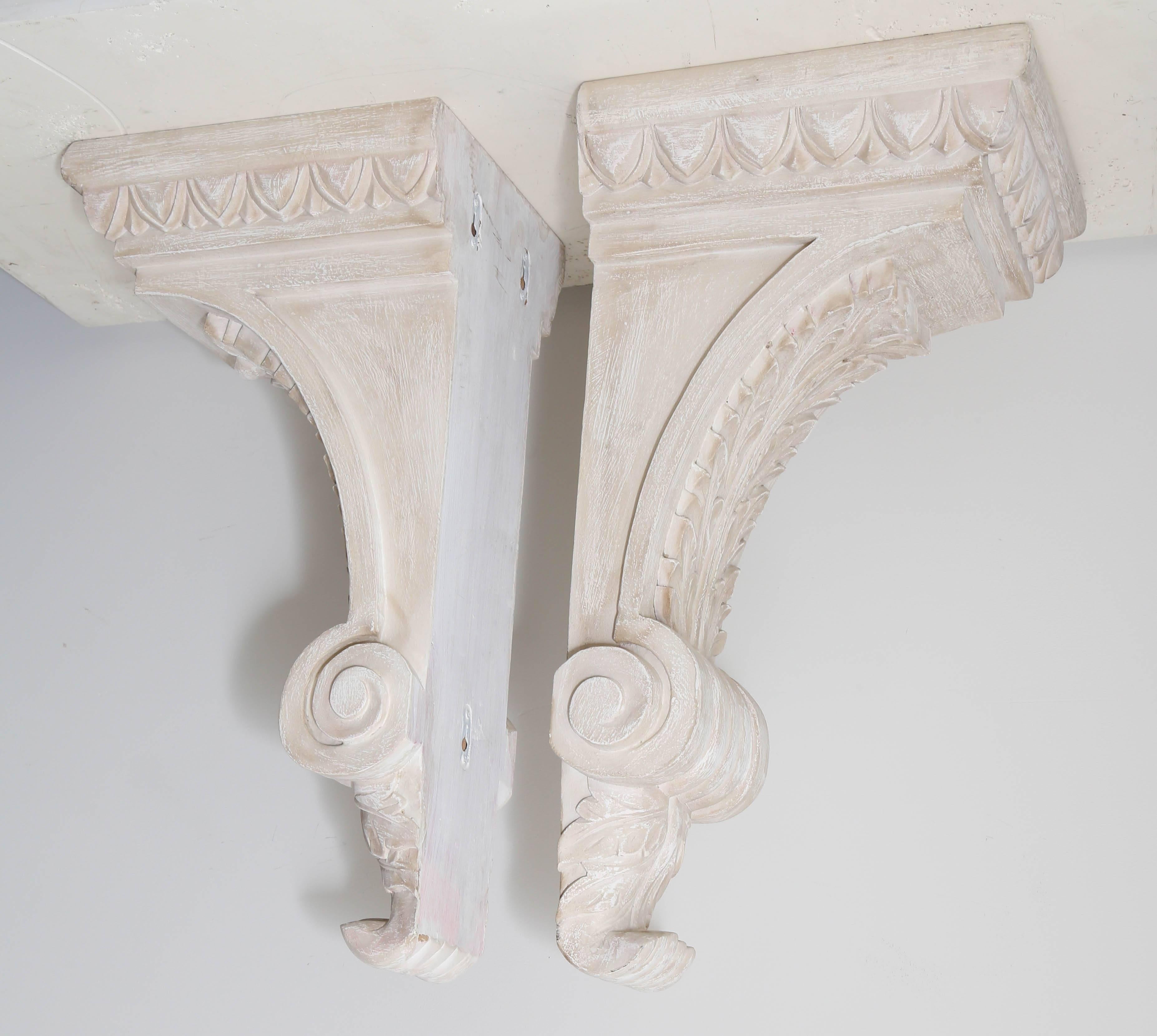 Pair of carved wood architectural wall brackets.