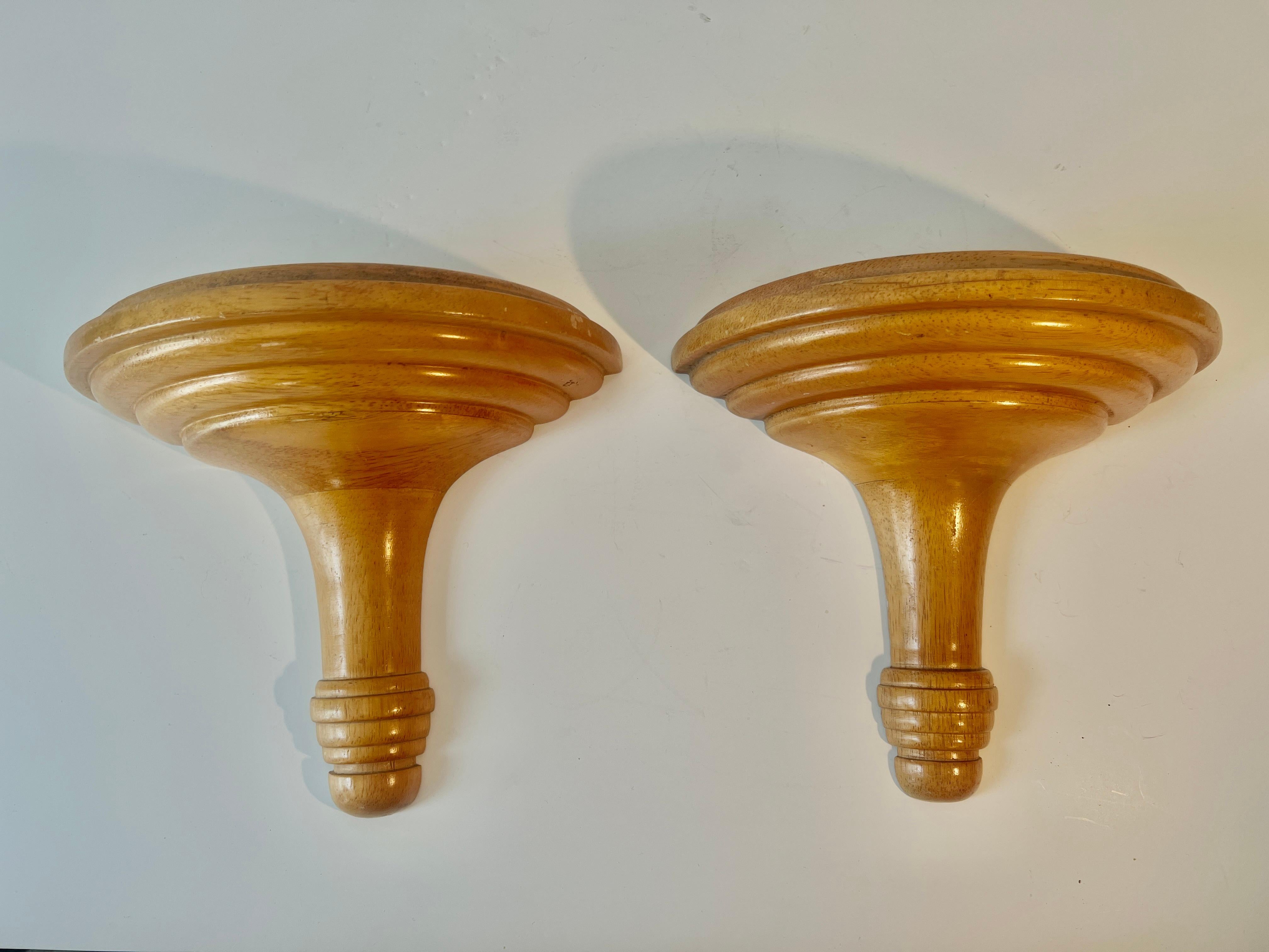A great pair of wooden wall mounted brackets.  The pieces are hand tooled and have a half circle on top.  In the photo are a pair of our monkey candlesticks.

The pair work anywhere - living room, den, Childs room, holding stuffed animals, a clock