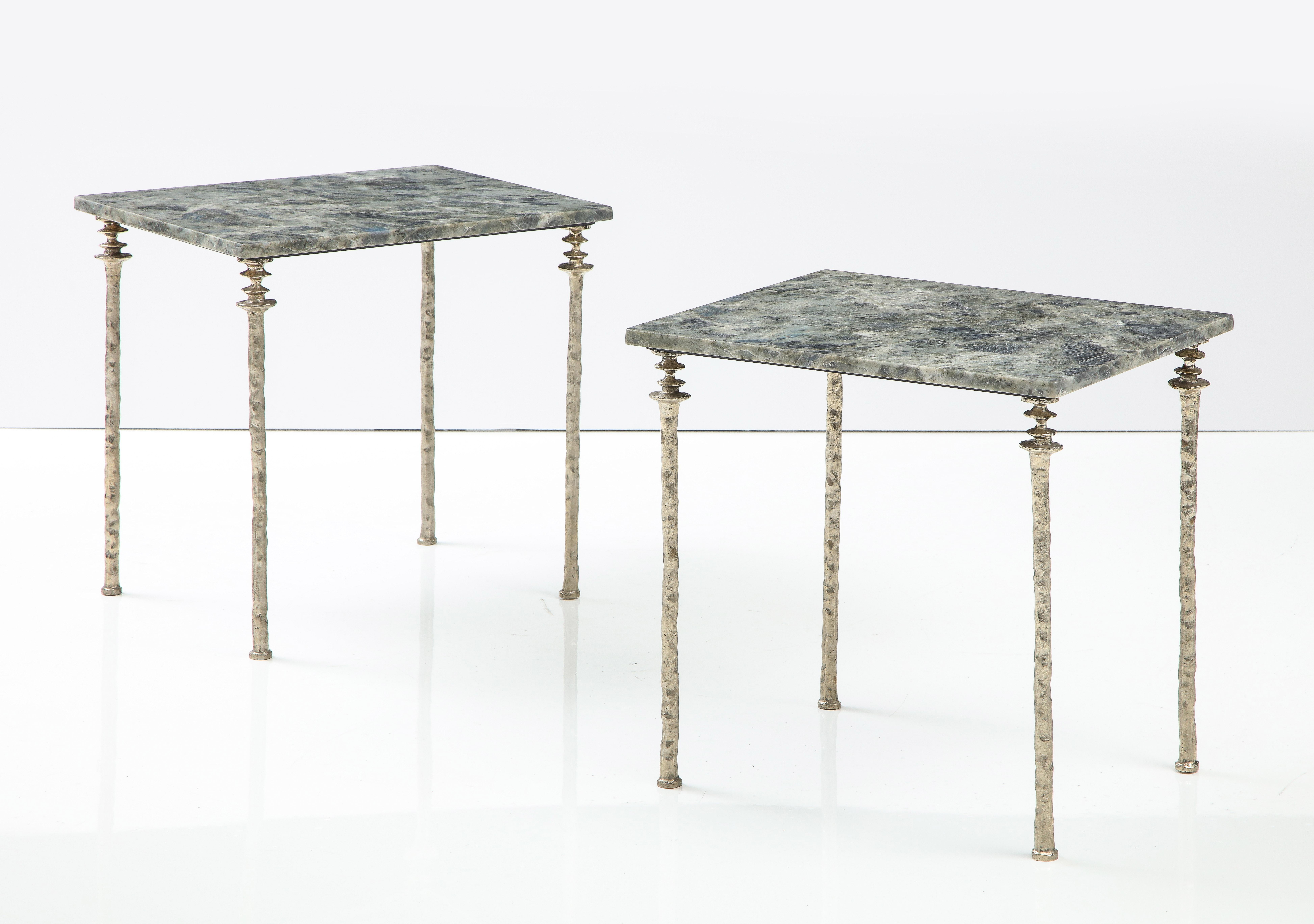 Two marble-topped side tables, with our signature legs. The legs are cast white bronze. Unique organic texture of the bronze legs. The marble on these pair is a grey/black/blue crystalized marble.