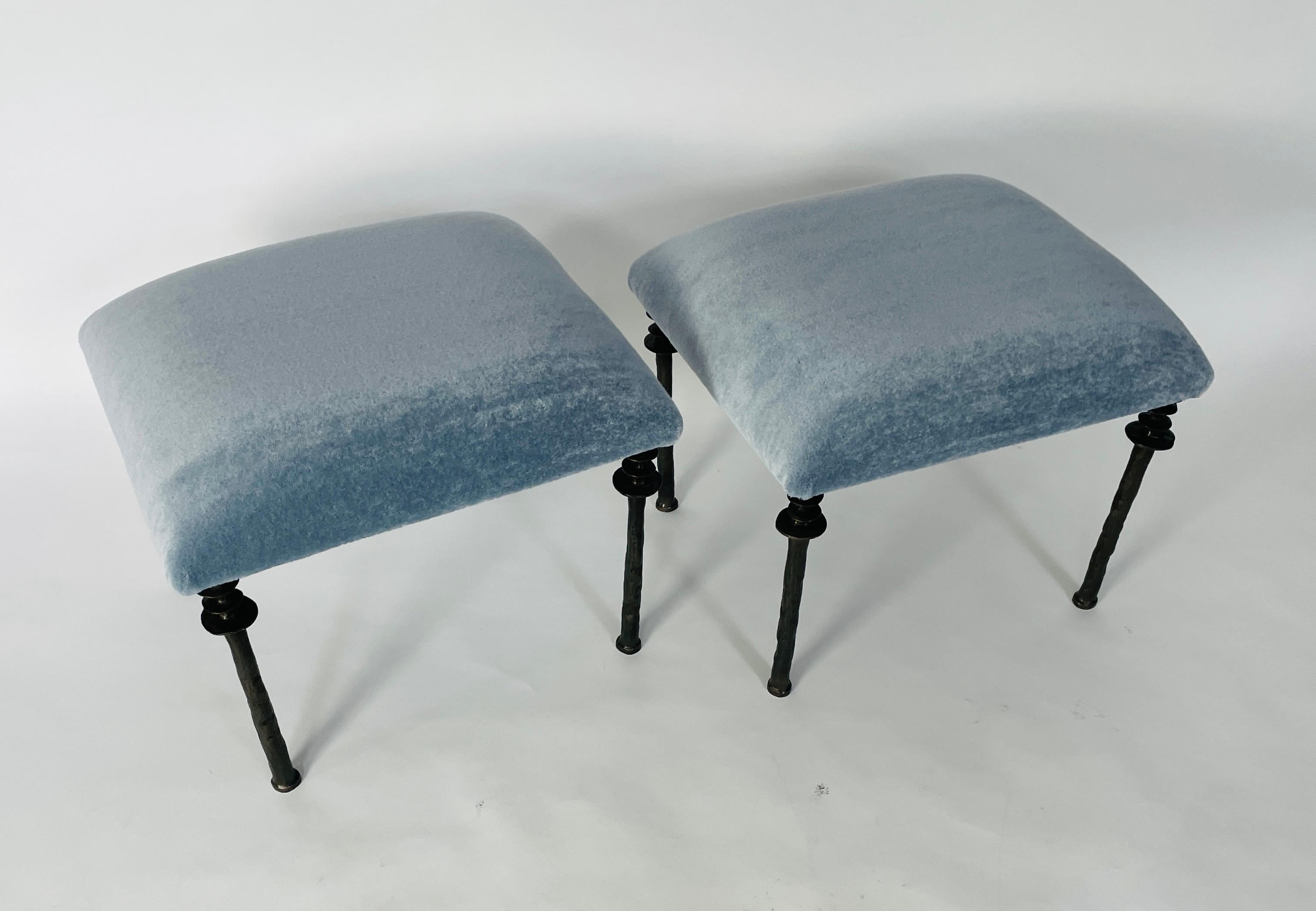 Two beautiful stools inspired by Diego Giacometti, these stools are ideal for those who are looking for unique seating. Their cast bronze legs provide a truly organic touch. The seat cushion has been upholstered with a light blue mohair fabric.