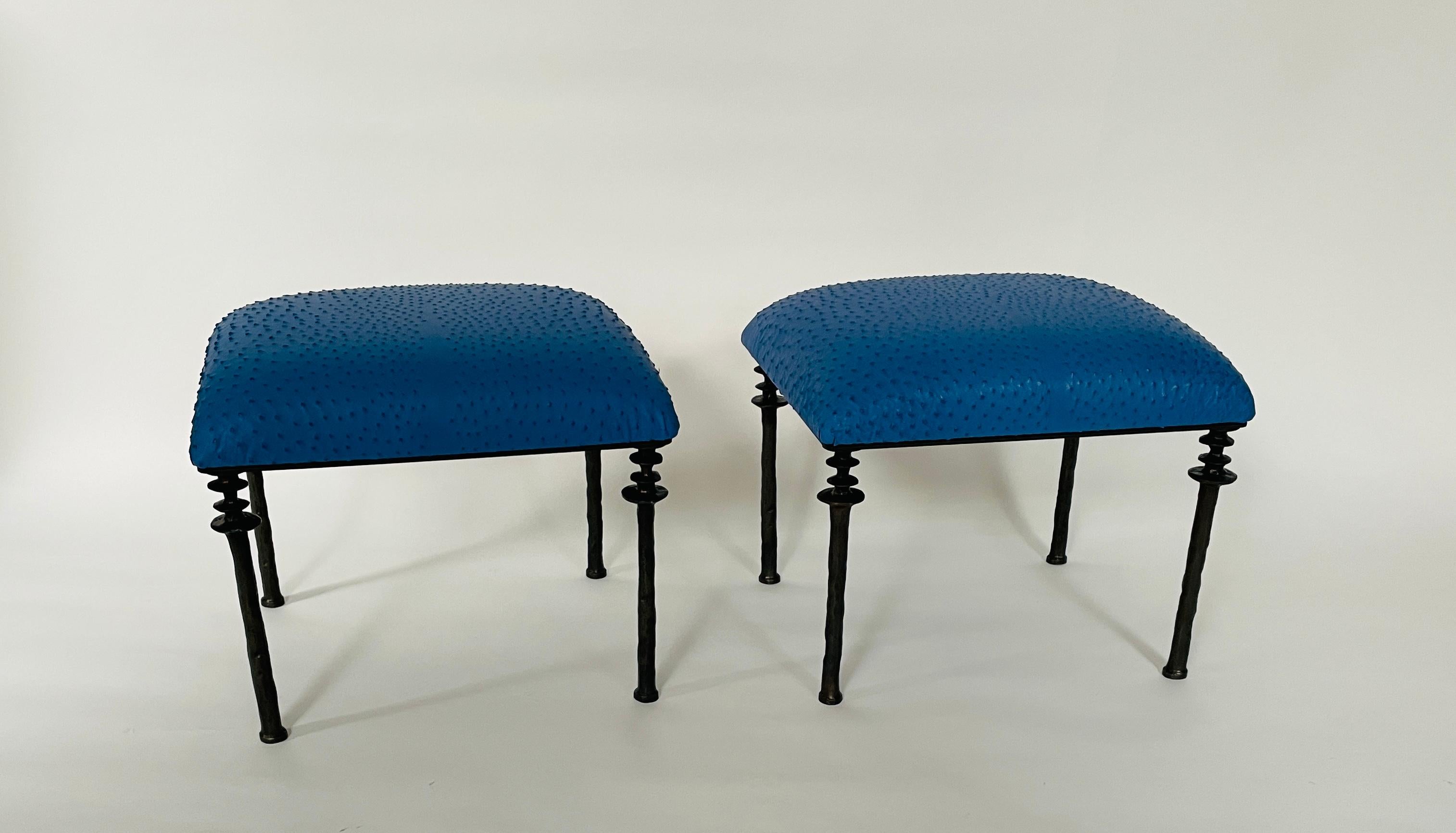 Two beautiful stools inspired by Diego Giacometti, these stools are ideal for those who are looking for unique seating. Their cast bronze legs provide a truly organic touch. The seat cushion has been upholstered in a blue farmed ostrich leather hide.