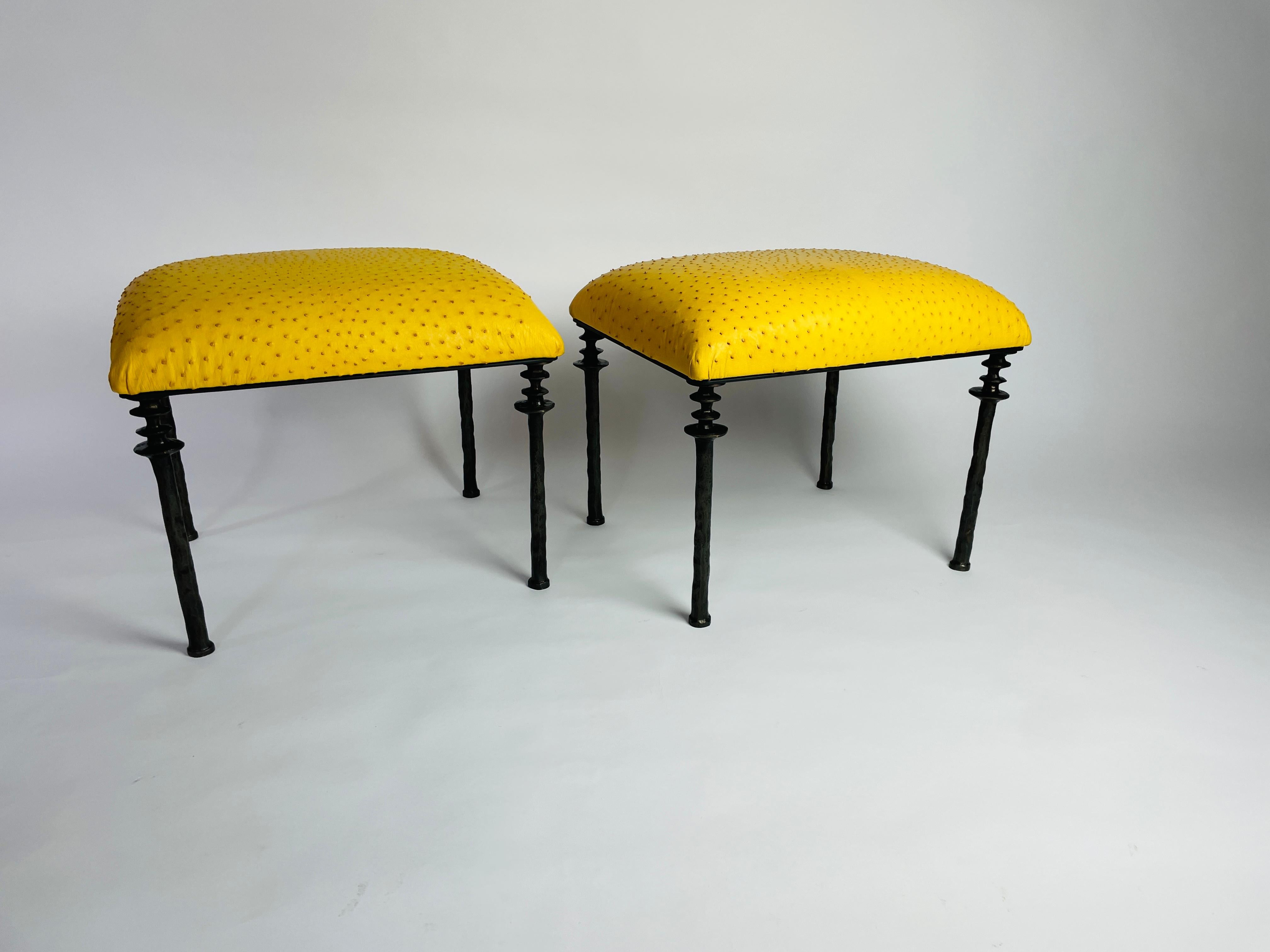 Two beautiful stools inspired by Diego Giacometti, these stools are ideal for those who are looking for unique seating. Their cast bronze legs provide a truly organic touch. The seat cushion has been upholstered in a striking citron yellow farmed