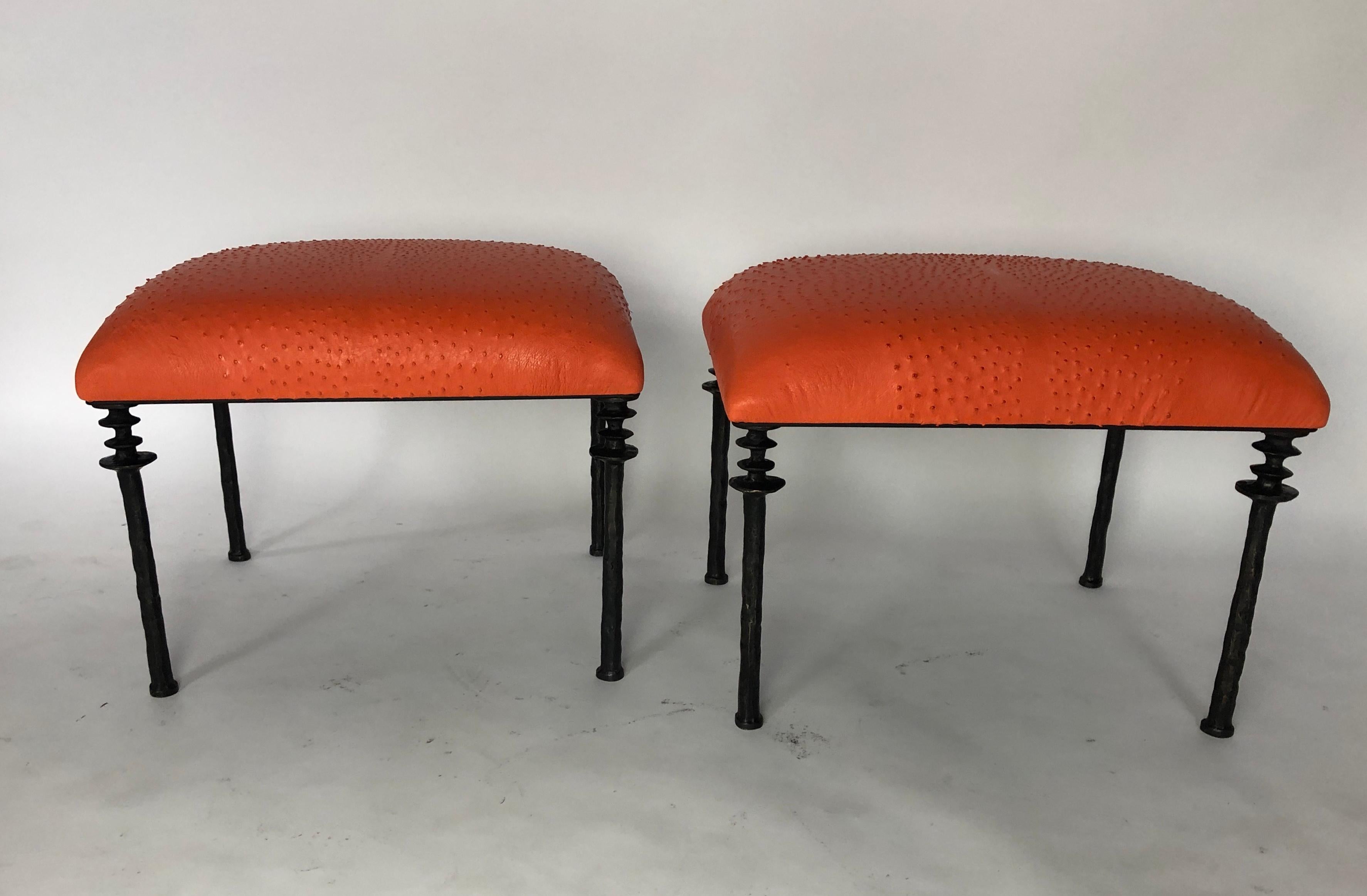 Two beautiful stools inspired by Diego Giacometti, these stools are ideal for those who are looking for unique seating. Their cast bronze legs provide a truly organic touch. The seat cushion has been upholstered in a striking tangerine ostrich