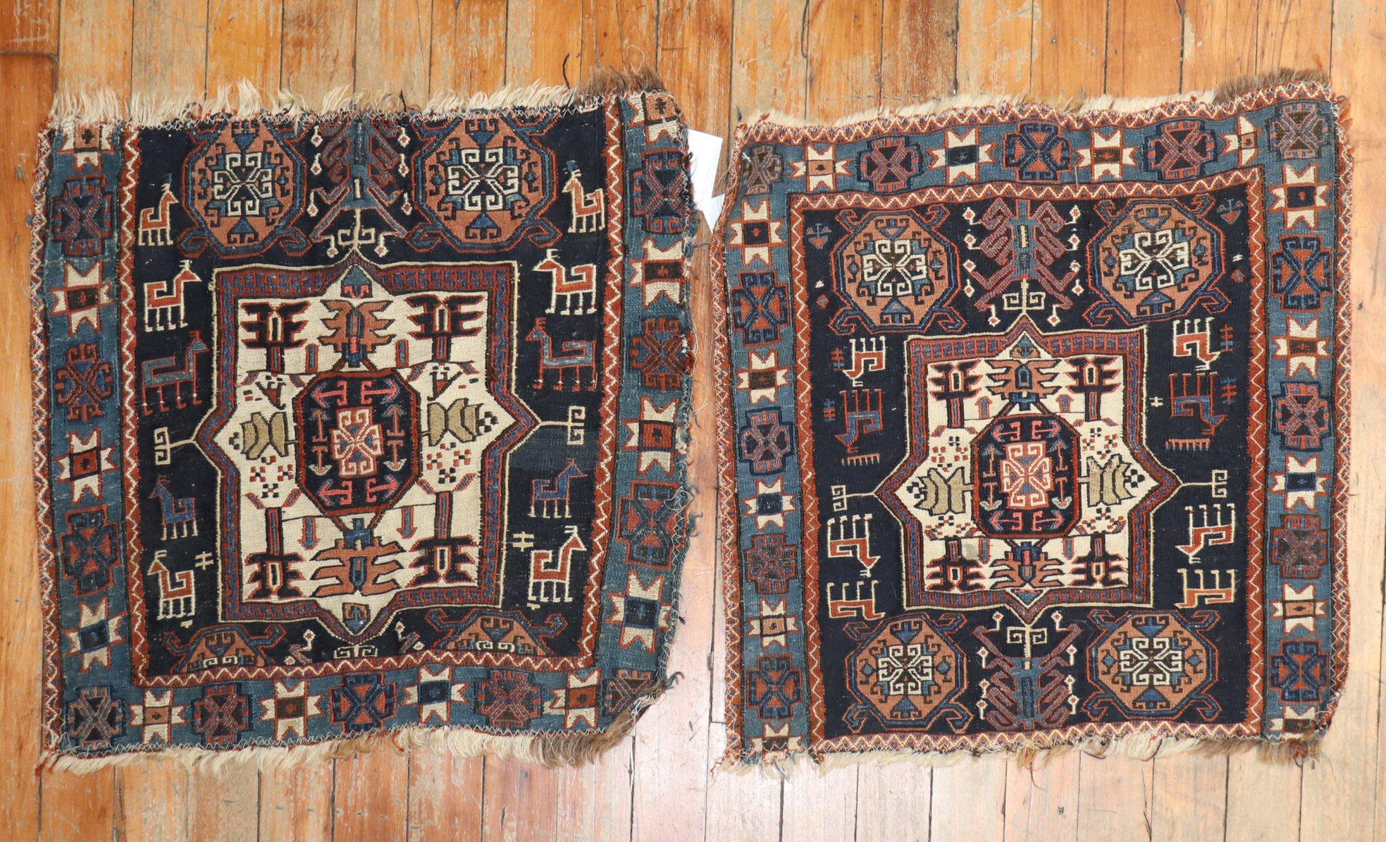 Pair of 19th-century Persian bag face textile rugs

each measuring: 1'6'' x 1'8''.